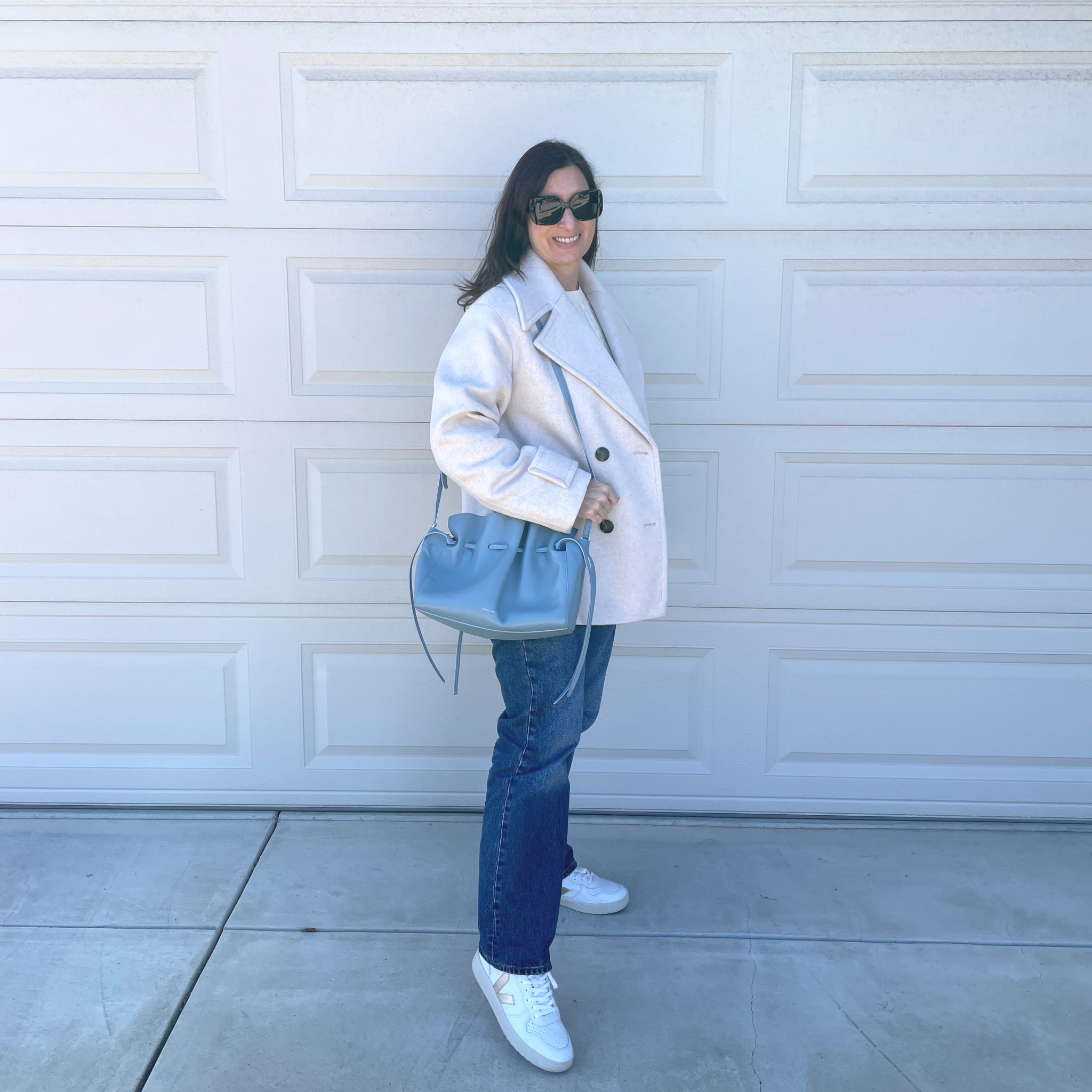 Loving return of drawstring bags in 2026 🙌 pulled this one out from the back of my closet 💃🏻 linked to similar blue drawstring bags and my coat is on sale by the way 🎉

#LTKOver40 #LTKootd #LTKSaleAlert