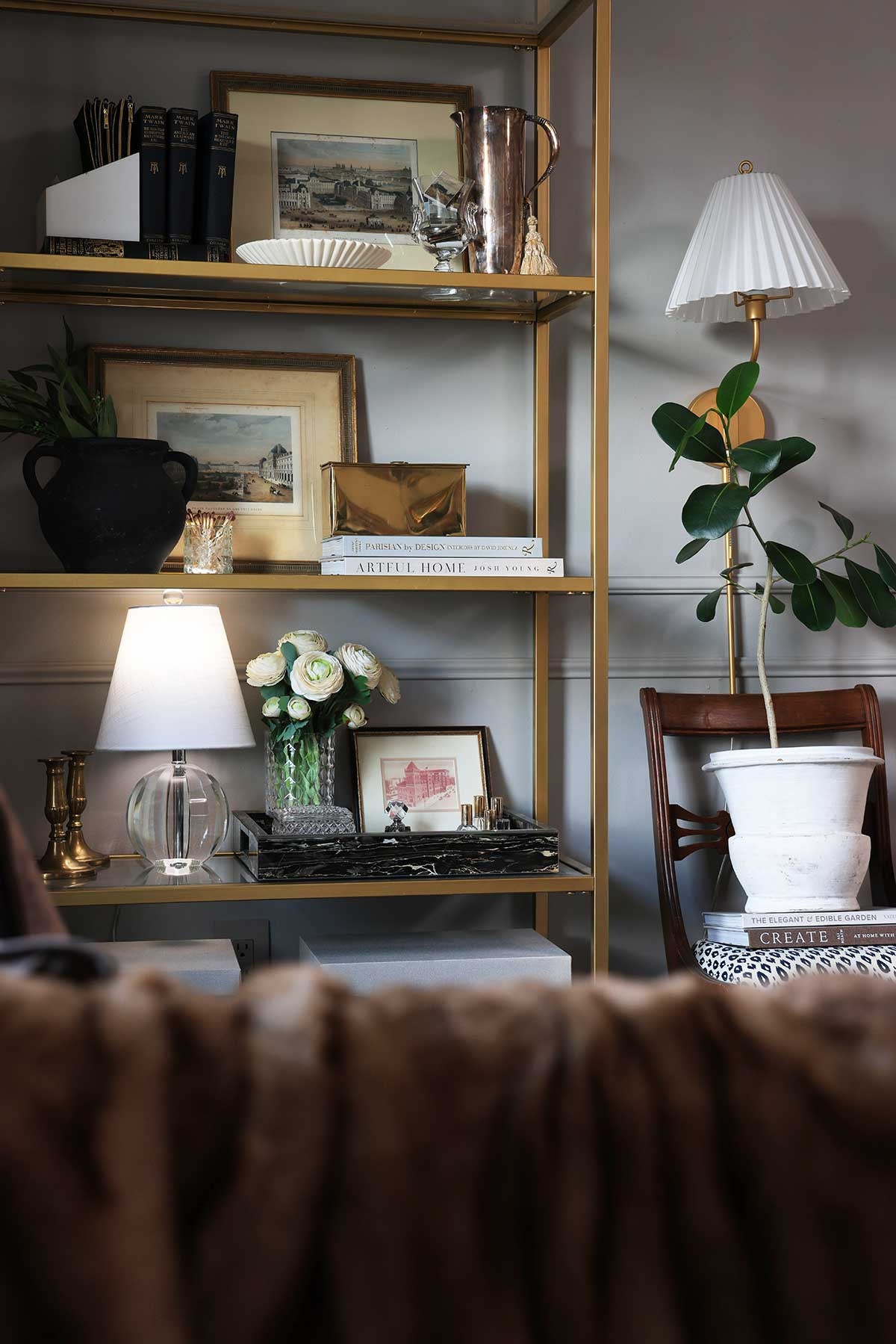 Great ways to style a bookcase corner: Stack decorative coffee table books, vintage books, prop art, small lamps, a vase with flowers, small trays, and finish things off with a sconce! 

 #LTKHome