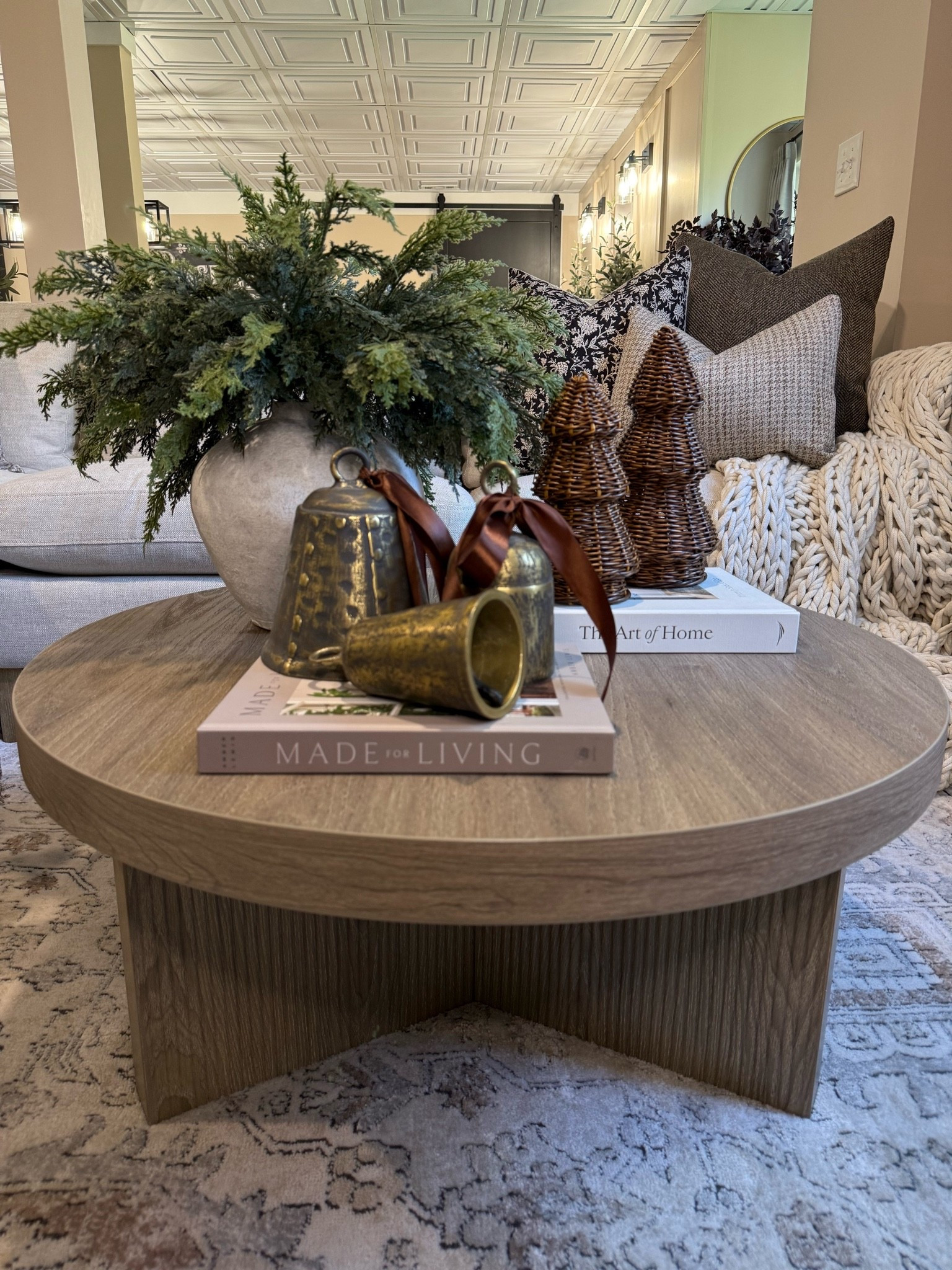 Neutral Christmas Coffee Table Styling — Amazon Finds

Follow @farmtotablecreations on Instagram for more cozy styling inspiration.

I started by adding the vase and lush evergreen stems for a natural, organic base. Next, I layered in a coffee table book to ground the look and placed the woven trees on top for height and texture. To finish, I added a set of brass bells tied with satin ribbon for a touch of warmth and festive charm. Every piece is from Amazon — simple layers that make a round coffee table feel full, balanced, and effortlessly cozy.

#coffeetablestyling #neutraldecor #livingroomdecor #holidaydecor #amazonfinds #amazonhome #roundcoffeetable #stylinginspo #brassbells #woventrees #evergreenstems #madeforliving #theartofhome #woodsandwhites #interiordecor #homedecorideas