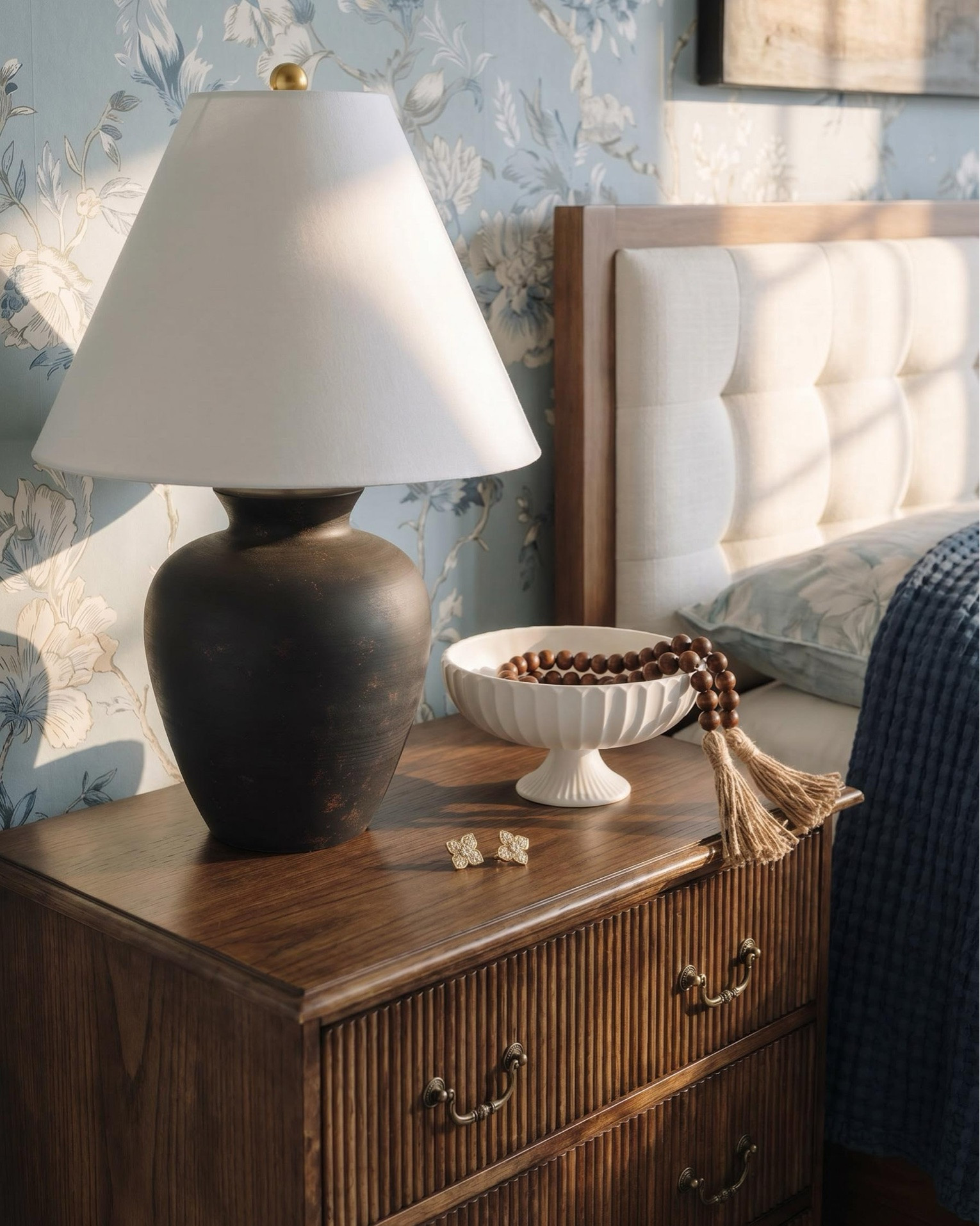 Shop the Look.
Bar Cabinet:
* Vase
* Rug/Runner
Bedroom:
* Bedroom upholstered bench 
* Blue throw blanket 
* Blue traditional rug 
* Dark wood oak nightstand 
* Black vase 
* Bedroom decor 
* White decor bowl 
* Blue wall paper
* Wall art 
Living Room:
* Cream upholstered sofas
* Upholstered accent chairs (clean, modern arms)
* Marble-look fireplace décor
* Solid wood coffee table
* Neutral vintage-style area rug
* Large ceramic jug vase
* Wood + ribbed side tables
* Warm wood built-ins (or shelf styling accents)
* Throw blankets in warm caramel tones
* Neutral patterned pillows

#LTKhome #LTKsale #LTKstyletip
