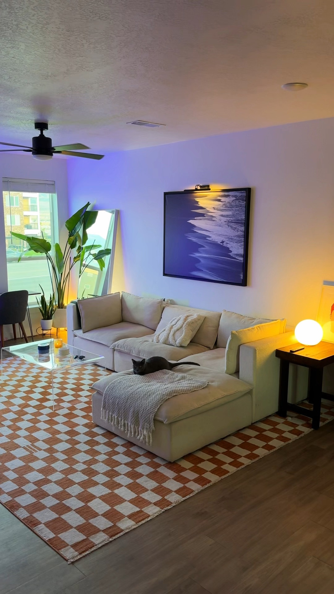 Livingroom Update 🪩

-

Funky 70s living room design with a orange checkered rug, white sectional cloud, couch, mood lighting mirrors, art with display lights, photo prints and surf imagery tall leafy plants .

#LTKHome #LTKSeasonal #LTKFindsUnder50