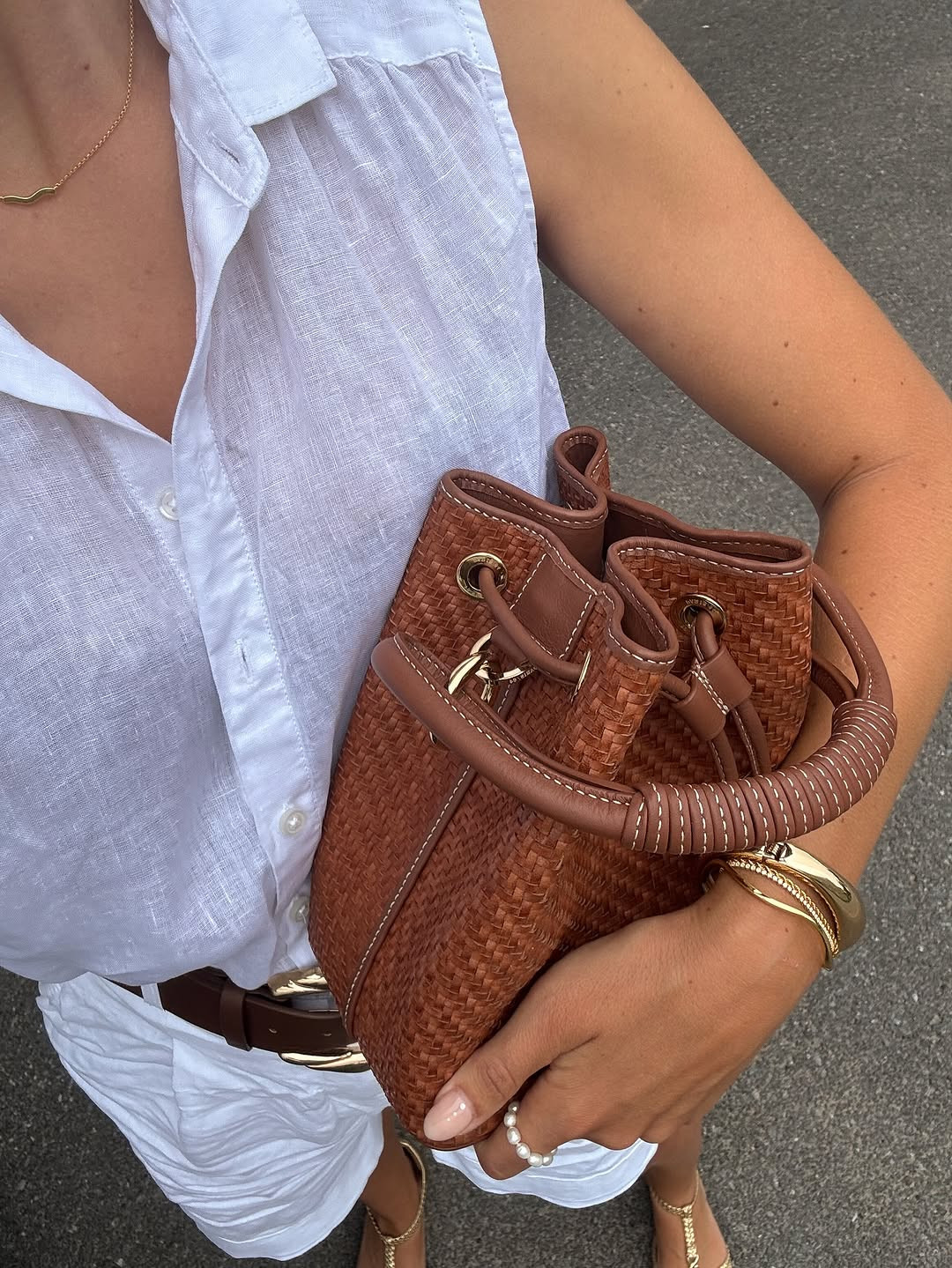 Summer neutrals at their best. This white linen set is elevated with a rich cognac woven bucket bag, a bold gold-buckle belt, and shimmering metallic flats. #LinenStyle #SummerNeutrals #LTKaccessories 

 #LTKdayinmylife #LTKgrwm #LTKootd