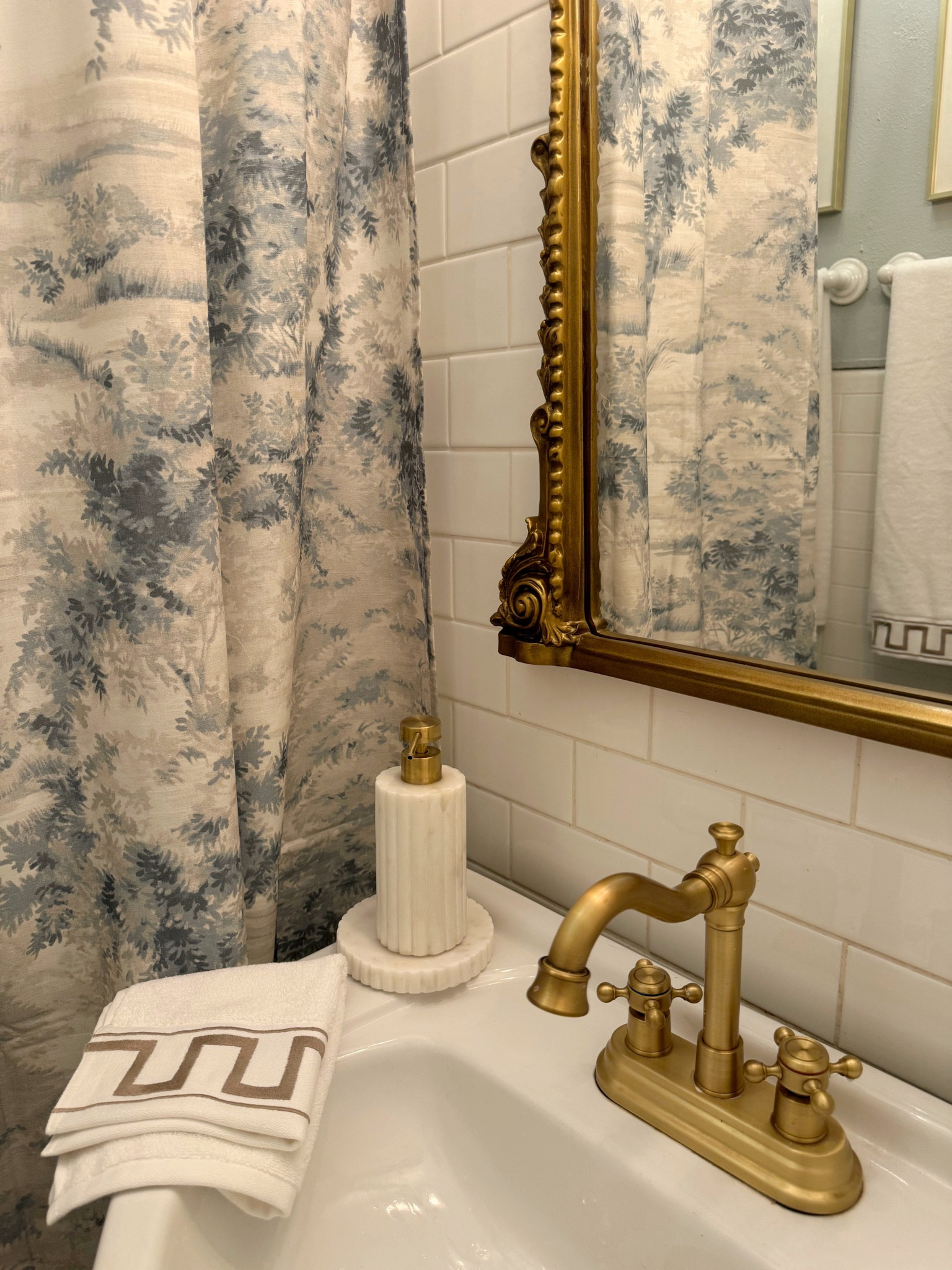 Bathroom accessories- shower curtain, gold $50 faucet, gold bathroom mirror, marble soap dispenser, hand towel 

#LTKstyletip #LTKsalealert #LTKhome