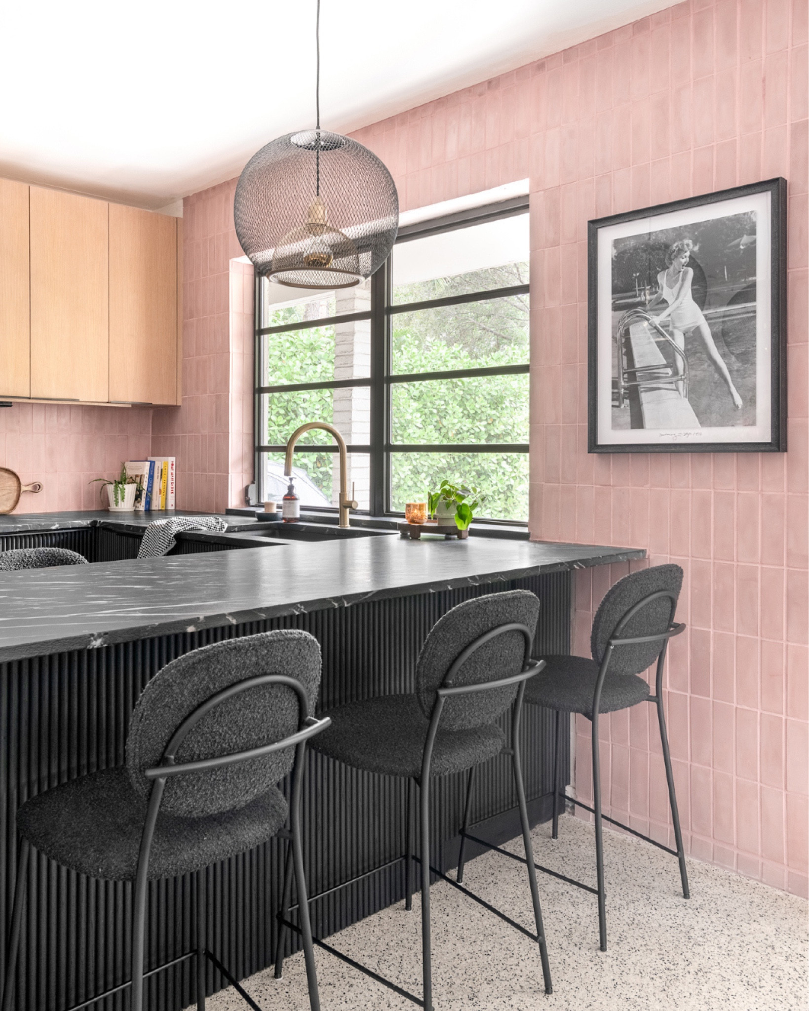 This pink, mid-century modern-inspired kitchen combines bold design choices, functional elegance, and a playful atmosphere that invites creativity.
Inspired to flow with the rest of the house, we balanced contrasting materials soft pink tiles, black fluted cabinetry, and light wood upper cabinets to create a harmonious yet striking space.

#LTKHome