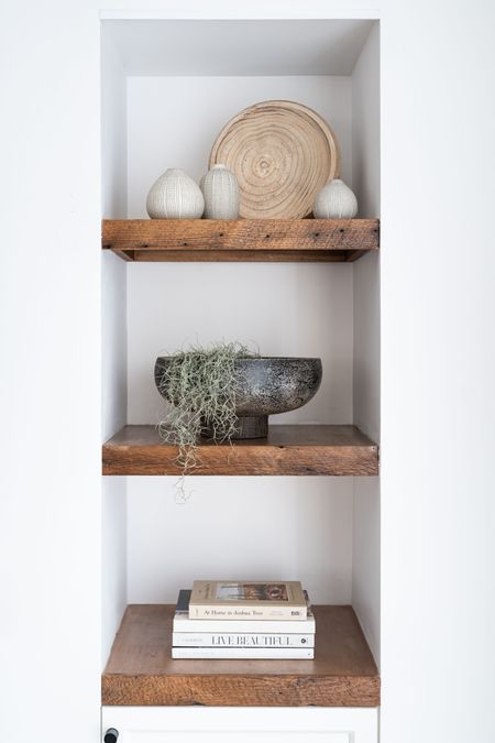 Living room shelves styled with vases, bowls and books for a clean, minimalist look.

Home decor , vases, wooden bowl, Spanish moss, books, modern bowl. 

#LTKunder50 #LTKhome
