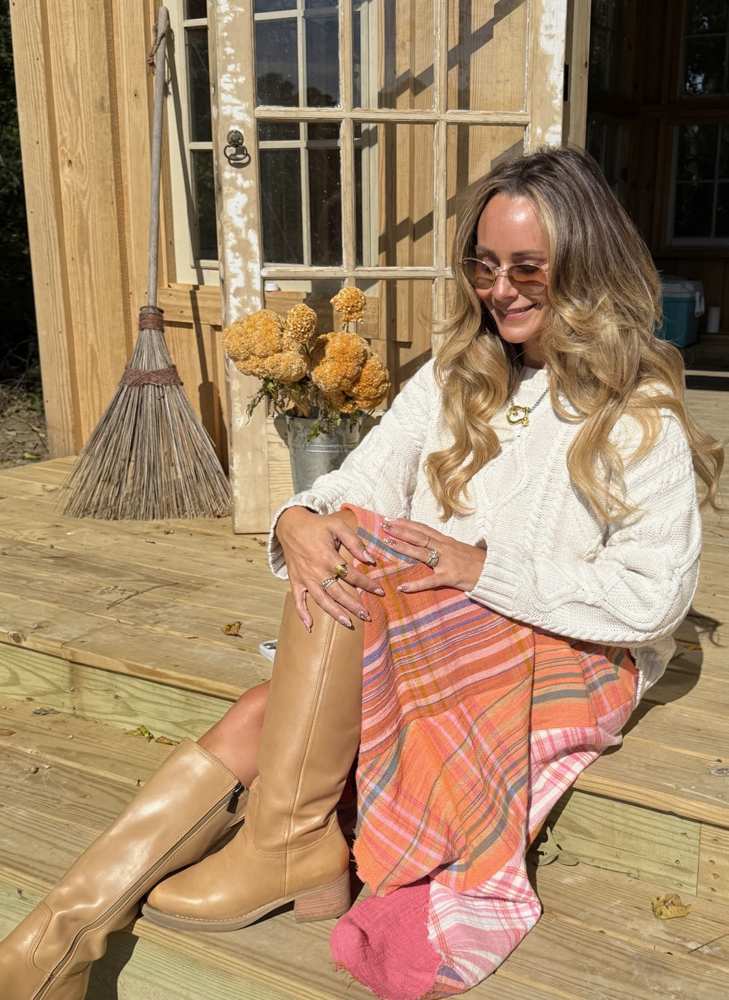 My favorite fall formula: a chunky cable-knit sweater, a fun skirt, and tall boots 🍂 This plaid patchwork skirt in orange and pink is the happiest thing in my closet, and the cream knit calms it right down. The boots have a low stacked heel, so I can actually walk in them. Sweater: M · Skirt: 6 · Boots: 8

Hashtags: #LTKstyletip #LTKover40 #LTKseasonal #LTKshoecrush