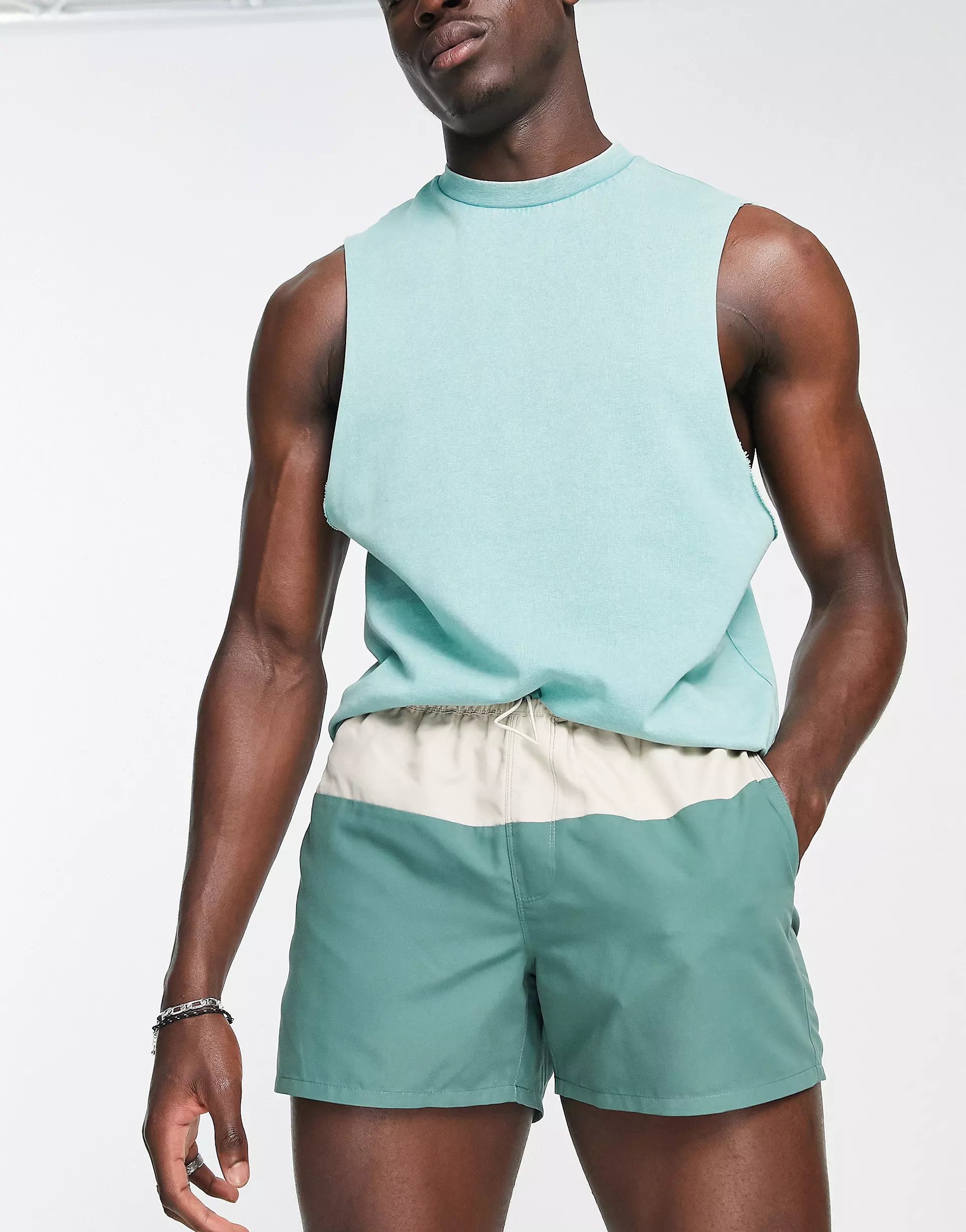 ASOS DESIGN swim shorts in short length with color block in green and beige | ASOS (Global)