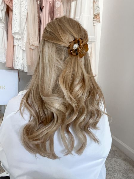 Flower hair clip accessory with soft curls. Use a texture spray to hold the curls and a bonding hair oil to keep your hair smooth. 

#LTKunder100 #LTKbeauty