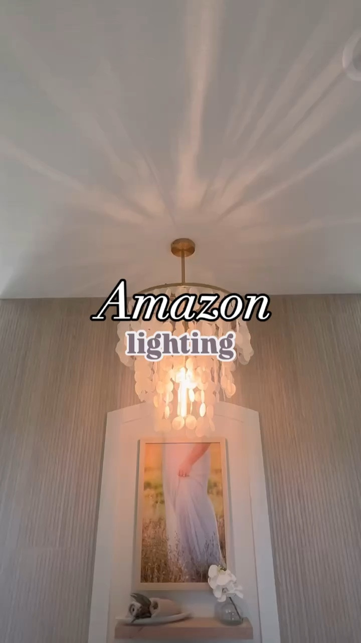 This chandelier was my final, but perfect touch to my spa-inspired master bath. The contrast between the off white shell drapes and the gold frame brings such a luxe and elegant feel to the room, but still offers a ‘welcome home’ feeling!

While the design is modern, it’s so versatile—you could easily use it in a dining room, bedroom, or even a living room, and it would be just as stunning. The white shell shade softens the light beautifully and creates a warm, inviting atmosphere. I love how the light changes throughout the day, depending on the brightness level and the bulbs used. It’s such a statement piece but still so functional!

If you’re thinking about adding a modern, elegant touch to your home, this is it!

 🔗 DM me for the link, and it’s also under my Amazon storefront! 

#BathroomChandelier #ModernLighting #HomeLighting #ElegantDesign #ChandelierGoals #GoldAndWhite #BathroomInspo #LuxuryBathroom #InteriorDesignIdeas #HomeDecorLovers #ModernHomeDecor #StatementLighting #LightingGoals #BathroomRemodel #InteriorGoals #LightFixtures #BathroomStyle #LuxuryHome #HomeRenovation #ChandelierDecor