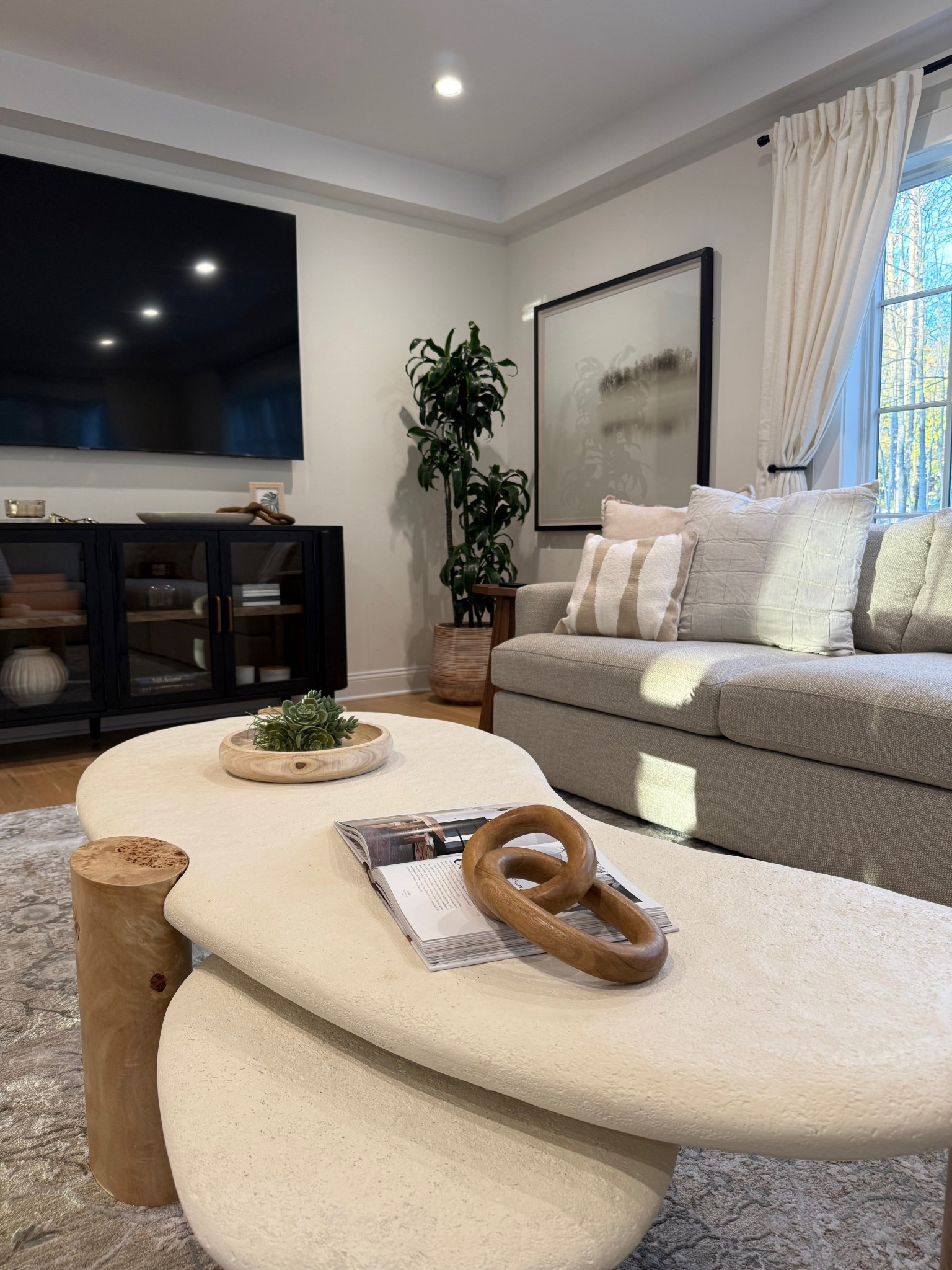 It’s all in the details — layered textures, curated objects, and a coffee table that grounds the living space.
