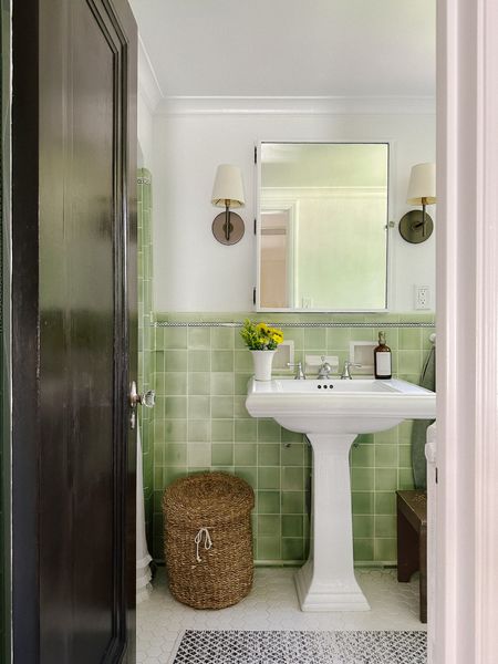 Our green bathroom. *kohler sink, fabric sconces (I like this sconce but the fabric is not great with the condensation), soap pump, seagrass hamper, sage towel.  

#LTKhome #LTKstyletip