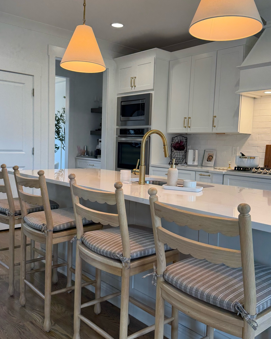 Neutral kitchen decor, brass kitchen lighting, kitchen pendant lights, fabric shade pendant, kitchen island lighting, kitchen island, counter stools, striped bar stools, traditional kitchen decor, kitchen remodel ideas, classic kitchen design, warm neutral kitchen

#LTKHome #LTKdayinmylife #LTKSeasonal