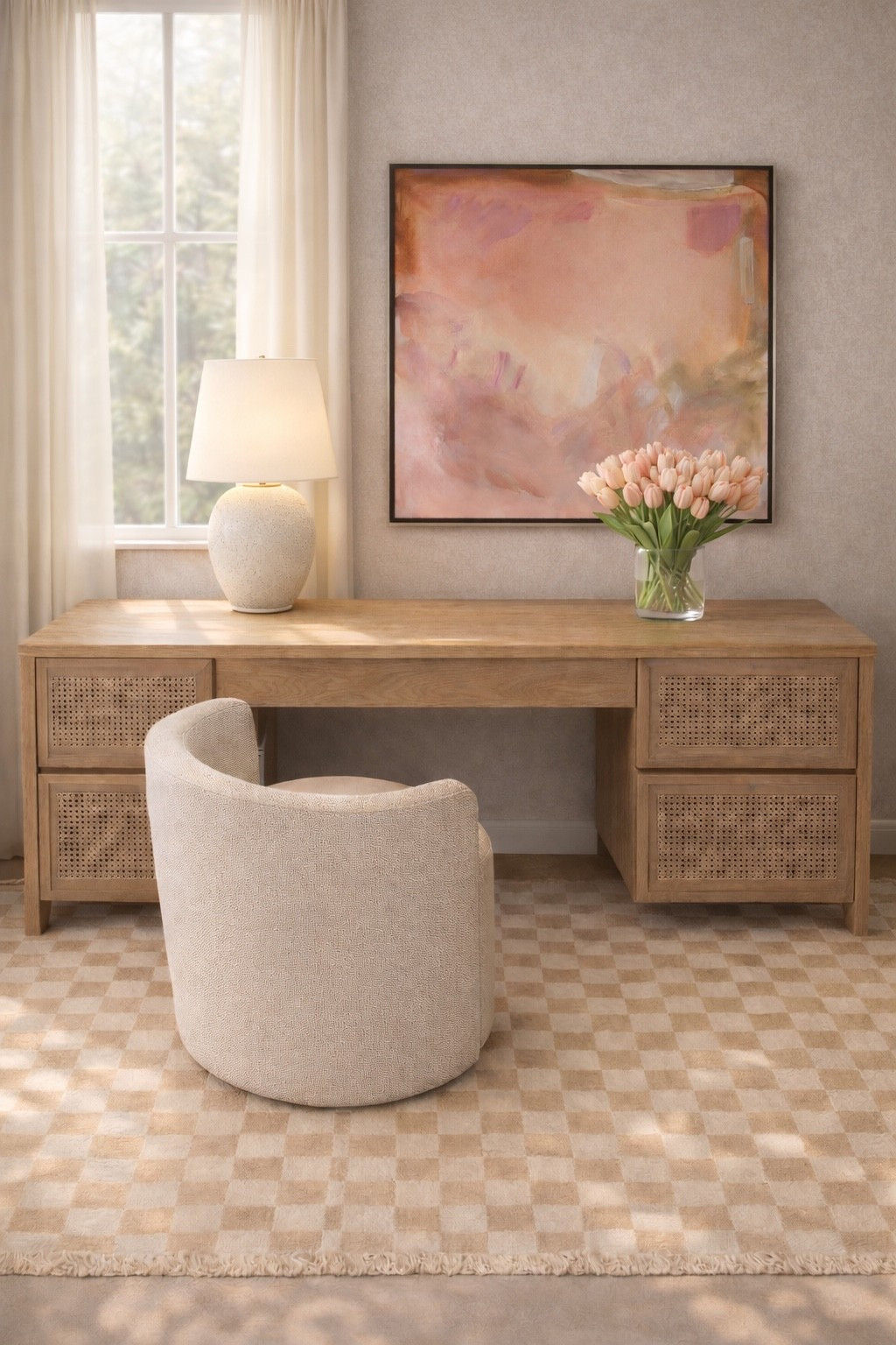 Spring home office inspiration 🌿

The checker rug brings a modern, chic foundation while still keeping the palette soft and neutral. I love how this rattan desk adds warmth and texture — natural materials always make a workspace feel more relaxed, breathable, and elegant.

The boucle barrel chair gives the space a sculptural look while still being incredibly comfortable. Paired with soft drapery and warm window light, this little workspace feels calm, airy, and perfect for slow spring mornings. #homeoffice
#homeofficeinspo
#checkerboardrug
#arearug
#rattandesk
#officedesk
#bouclechair
#barrelchair
#sheercurtains
#windowdrapes
#deskdecor
#springhome #tablelamp #art #floralarrangement

#LTKSpringSale #LTKHome #LTKFestival