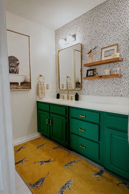 Bathroom inspo. This is our boys bathroom. It was such a joy to design and create. 

Cheetah rug, anthropologie, buffalo art, floating shelves, gold faucet, green vanityy

#LTKHome #LTKSaleAlert #LTKStyleTip