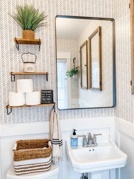 Small bathroom inspiration | neutral powder room | modern farmhouse bathroom | large black framed rectangular mirror | pedestal sink | wood shelves

#LTKFind #LTKhome #LTKstyletip