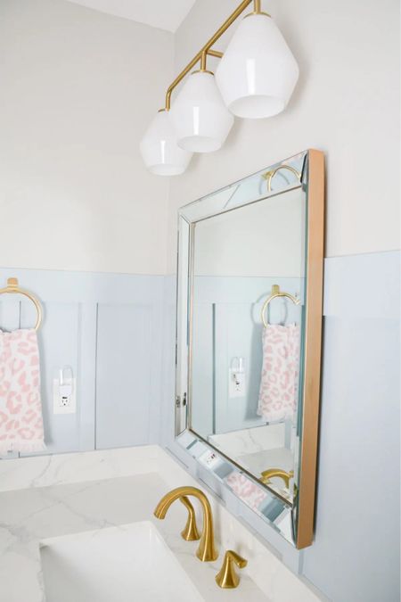 Pastel bathroom with gold vanity light fixture and modern brass faucet. #bathroom #boho #bathroomlight #midcenturymodern

#LTKHome #LTKSaleAlert