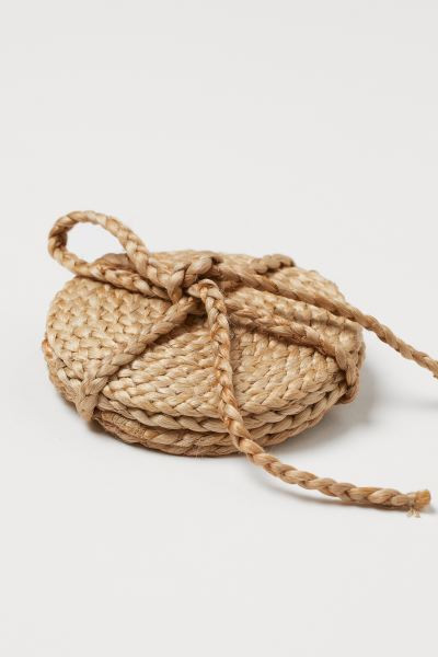 Round, handmade coasters in jute. | H&M (US + CA)