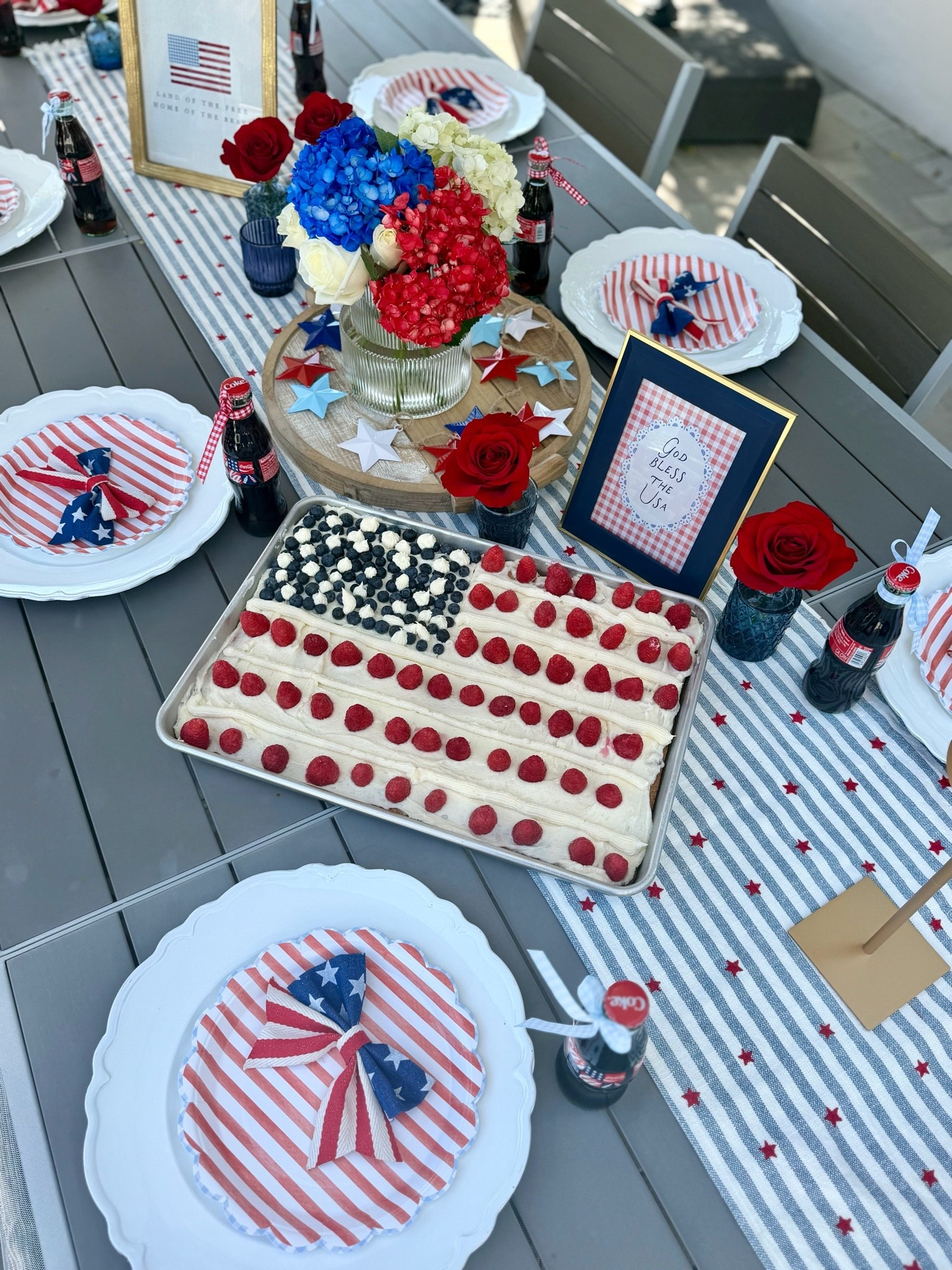 Red, white, and beautiful ❤️🤍💙

Loved styling this patriotic tablescape for our Memorial weekend BBQ. I wanted something that felt classic, elegant, and a little bit nostalgic.

A gorgeous mix of red, white, and blue hydrangeas paired with vintage-inspired glass Coca-Cola bottles tied up in crisp gingham ribbon. Add a few festive stars, vintage USA framed prints, striped plates with bow details, and a glittered champagne bottle for that perfect touch of holiday sparkle. And this yummy flag cake by @kristintaylorfit 🇺🇸 

The best part is you have a setup that easily transitions from Memorial Day straight into the 4th of July! ✨🍾

Whether you’re hosting a big family barbecue or an intimate backyard gathering, a beautiful table always sets the mood. Cheers!! 

#TablescapeDesign  #4thOfJulyInspo #RedWhiteAndBlue

#LTKfoodie #LTKHome #LTKSeasonal