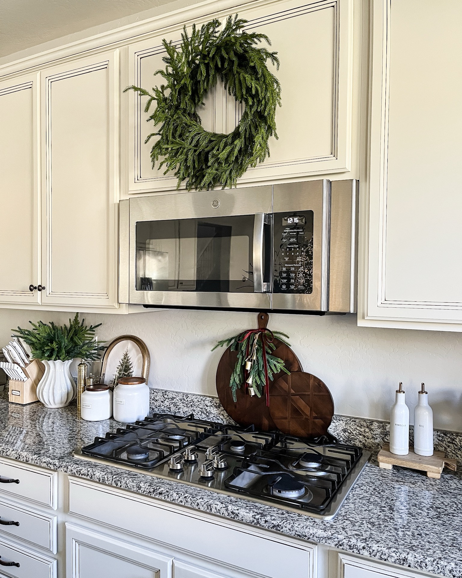 Christmas kitchen decor! Follow @lifeinmyarizonahome on Instagram for more holiday ideas and inspiration. 

Sharing a simple idea to dress up any wood handled board in your kitchen that makes such a festive impact!  
I used one 24 inch Norfolk stem with the stem folded back, velvet ribbon, and these adorable gold bells that I attached together with jute string.  I’m loving these bells that can be added as decor around your home or tied onto a gift. I definitely plan on making a few more of these hanging bells!

#christmasdecor #holidaydecor #holidaykitchen #simplediy 

#LTKHoliday #LTKSeasonal #LTKHome