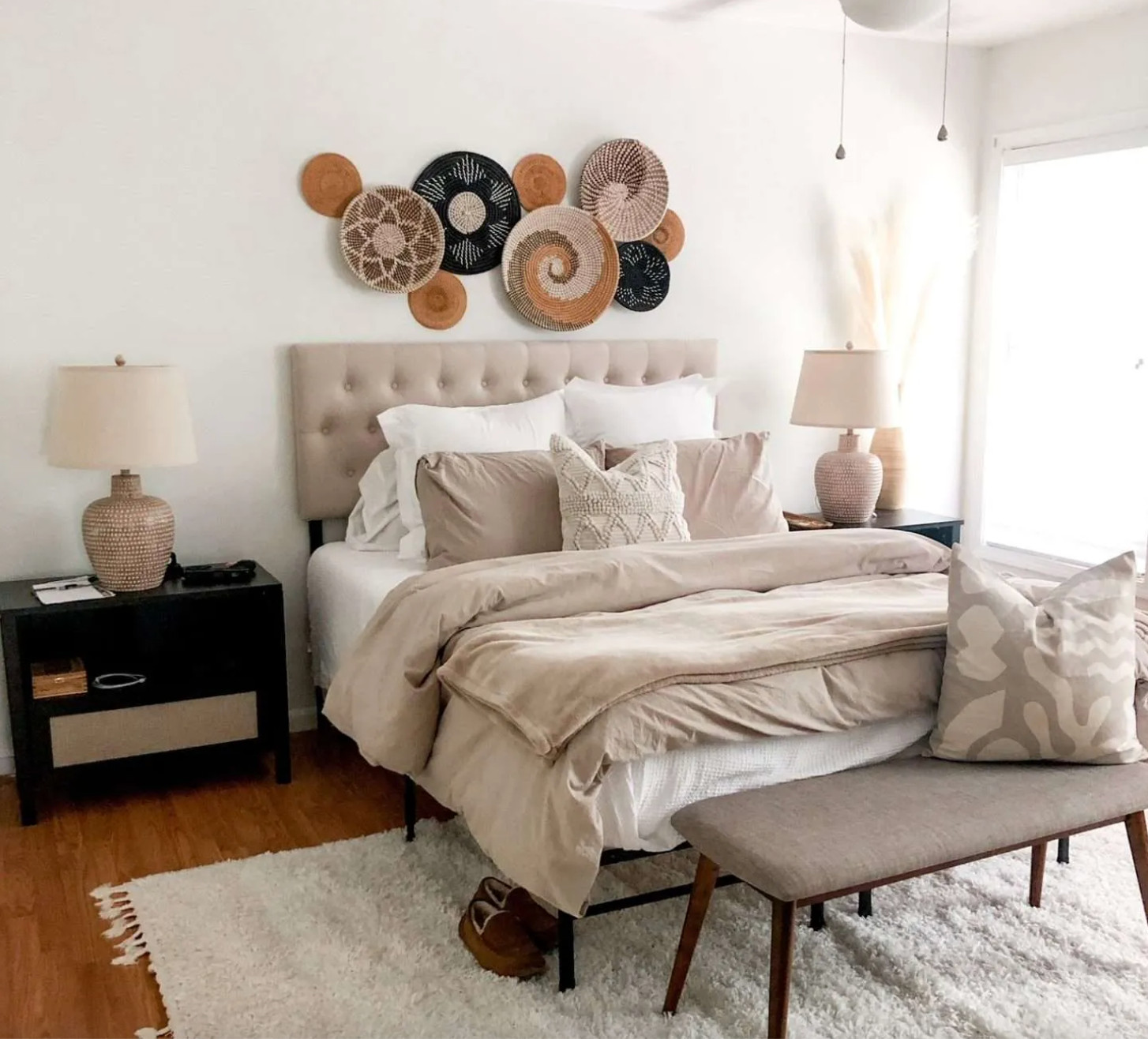 Neutral bedroom decor · woven wall baskets · linen tufted headboard · beige bedding · cozy bedroom styling · warm earthy bedroom · boho neutral bedroom · bedroom bench · shag rug · ceramic table lamp
Everything in this photo is linked — the baskets, headboard, bedding, lamps, rug, bench, and pillows. This is the neutral, earthy bedroom aesthetic that actually feels calm to live in, not just pretty in photos. Shop the full room below. Full details on the blog. #bohobedroom #neutralbedrooom #bedrroommakeover #basketwall 

 #LTKOver40 #LTKHome #LTKSaleAlert