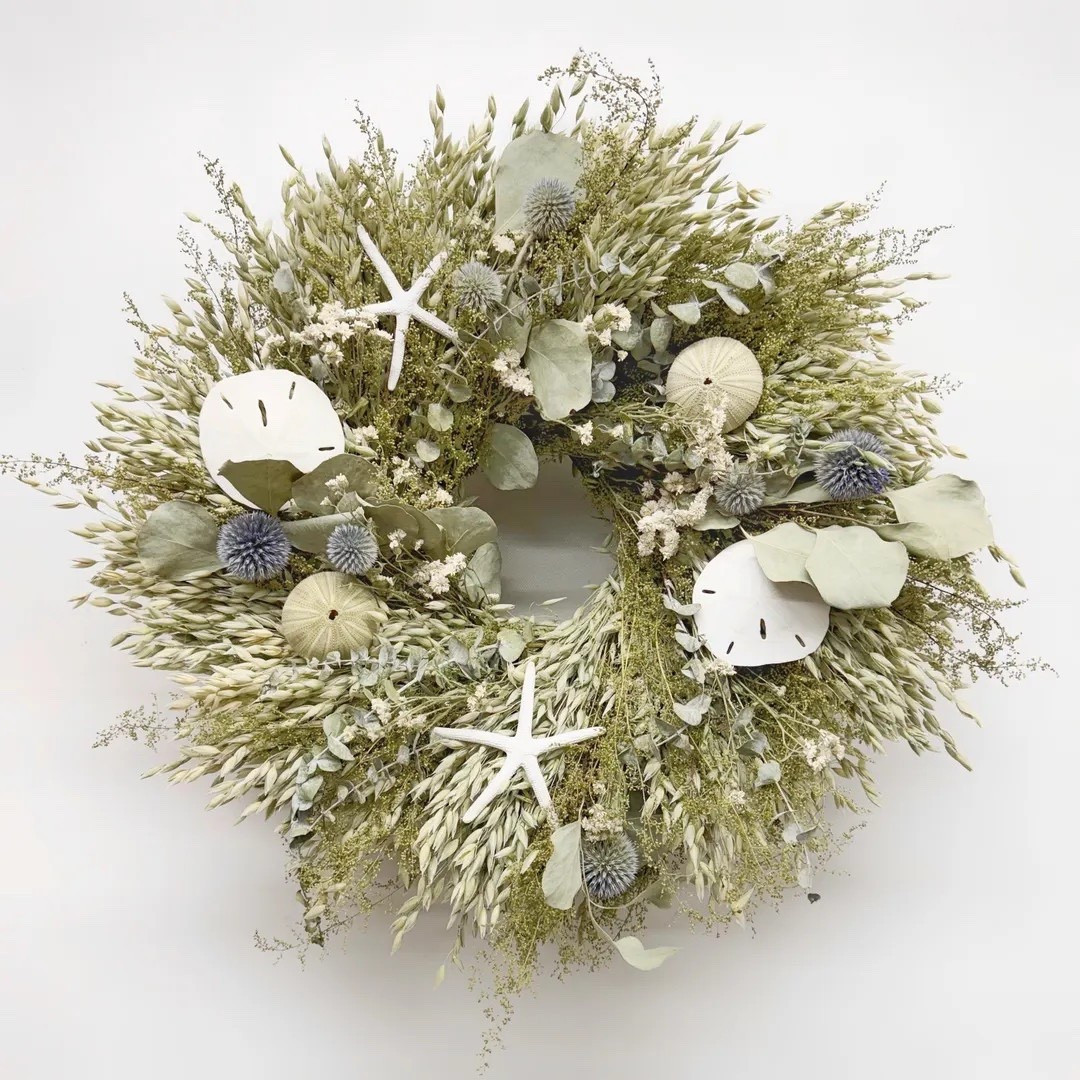 Bring coastal calm into your home with the Harbor Salt wreath, a beautiful blend of dried botanicals and seaside treasures. Air-dried avena oats, sweet annie, globe thistle, and soft eucalyptus create a windswept texture, while real sand dollars, sea urchins, and starfish add a subtle ocean-inspired touch. This handcrafted wreath captures the relaxed elegance of the shore and makes a stunning accent for doors, walls, or beach-inspired spaces. #ltkhome #ltkstyle #coastaldecor #beachhouse #driedflowers #coastalhome #wreathdecor #naturaldetails

#LTKHome #LTKSeasonal