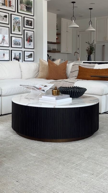 coffee table styling with the new round coffee table in our living room! Love the fluted detail on this with the marble top. Styling with a marble ruffle bowl, acrylic book stand and marble box to hold Knick knacks in addition to coffee table books. Also linking our white sofa, area rug and throw pillows  

#LTKstyletip #LTKsalealert #LTKhome