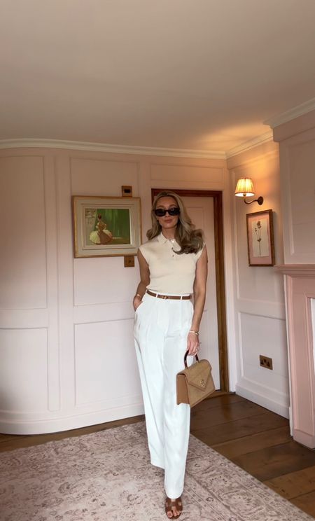 A preppy, tonal look styling white trousers and a sleeveless button polo

#LTKSeasonal #LTKworkwear #LTKitbag