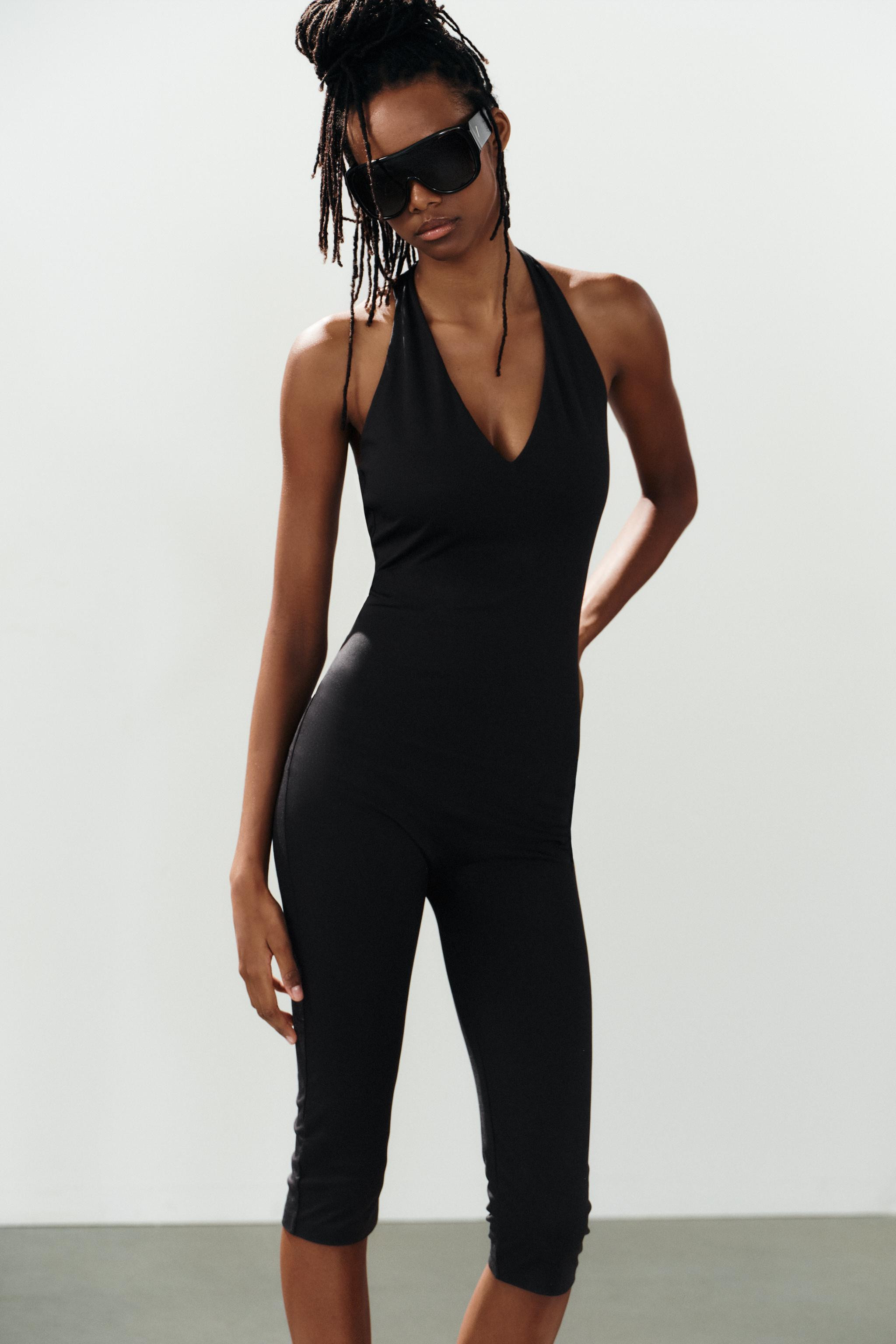 Jumpsuit made of stretch fabric. Features a halter neck and V-neckline. Above-the-knee length. | Zara US