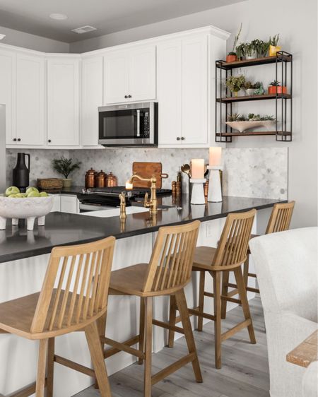 This white kitchen is brought to life by dark quartz countertops.

#LTKhome