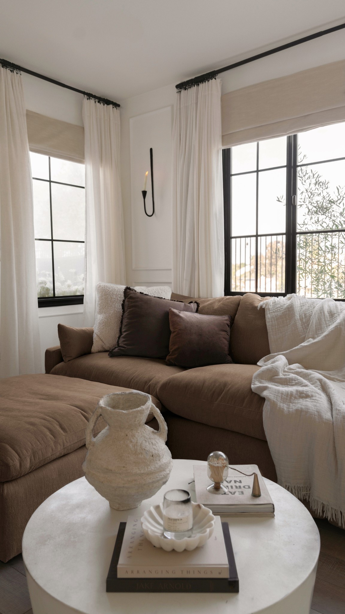 Still not over these gorgeous window panes 🤎 details on IG! Same username @evaacatherine 

Couch is from Living Spaces 
Window grids are from New Panes
Black pain is Tricorn Black by SW and I used Behr Satin Black spray-paint
Walls are Polar Bear by Behr