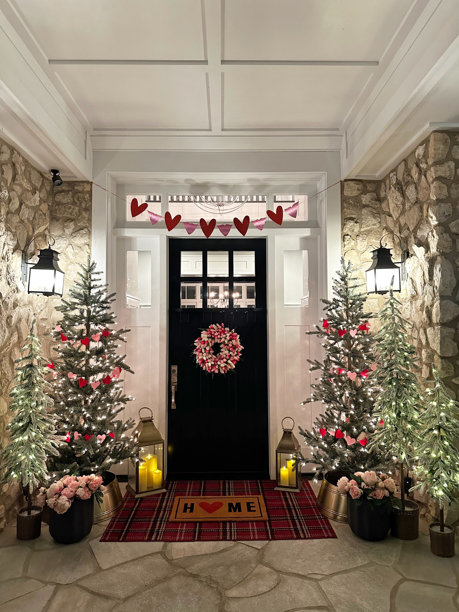 My Valentine’s Day porch all lit up at night! I keep my Christmas trees up Jan & Feb and wrap a heart banner around them. I added some pink peonies and a beautiful tulip wreath!  

#LTKhome #LTKSeasonal
