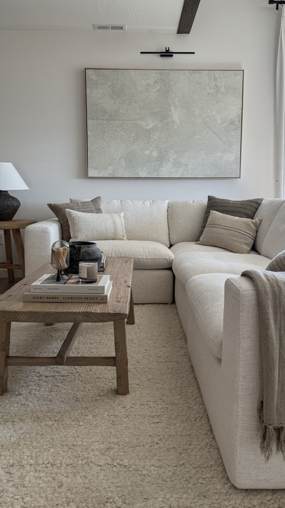 Neutral organic modern living room featuring a cozy sectional, rustic wood coffee table, textured throw pillows, and earthy home decor accents. This modern neutral home design blends organic textures with warm earth tones, creating the perfect balance of comfort and style. Shop my Amazon home finds and cozy organic modern decor to recreate this look in your own home. 

 #LTKHome