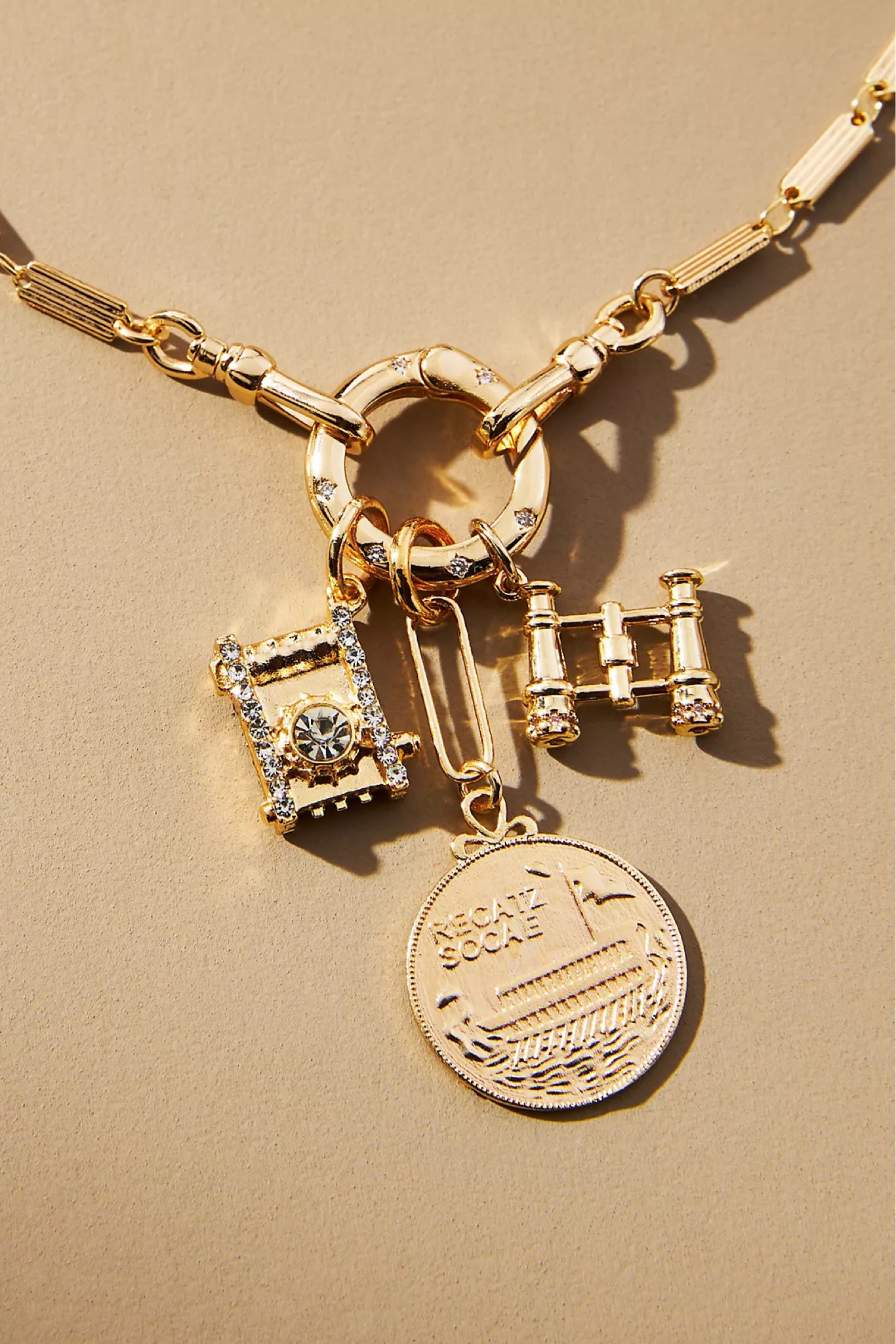 Anthropologie gold charm necklace with camera, binocular and vintage coin charm. Gifts for travelers 

#LTKGiftGuide #LTKfindsunder50 #LTKfindsunder100