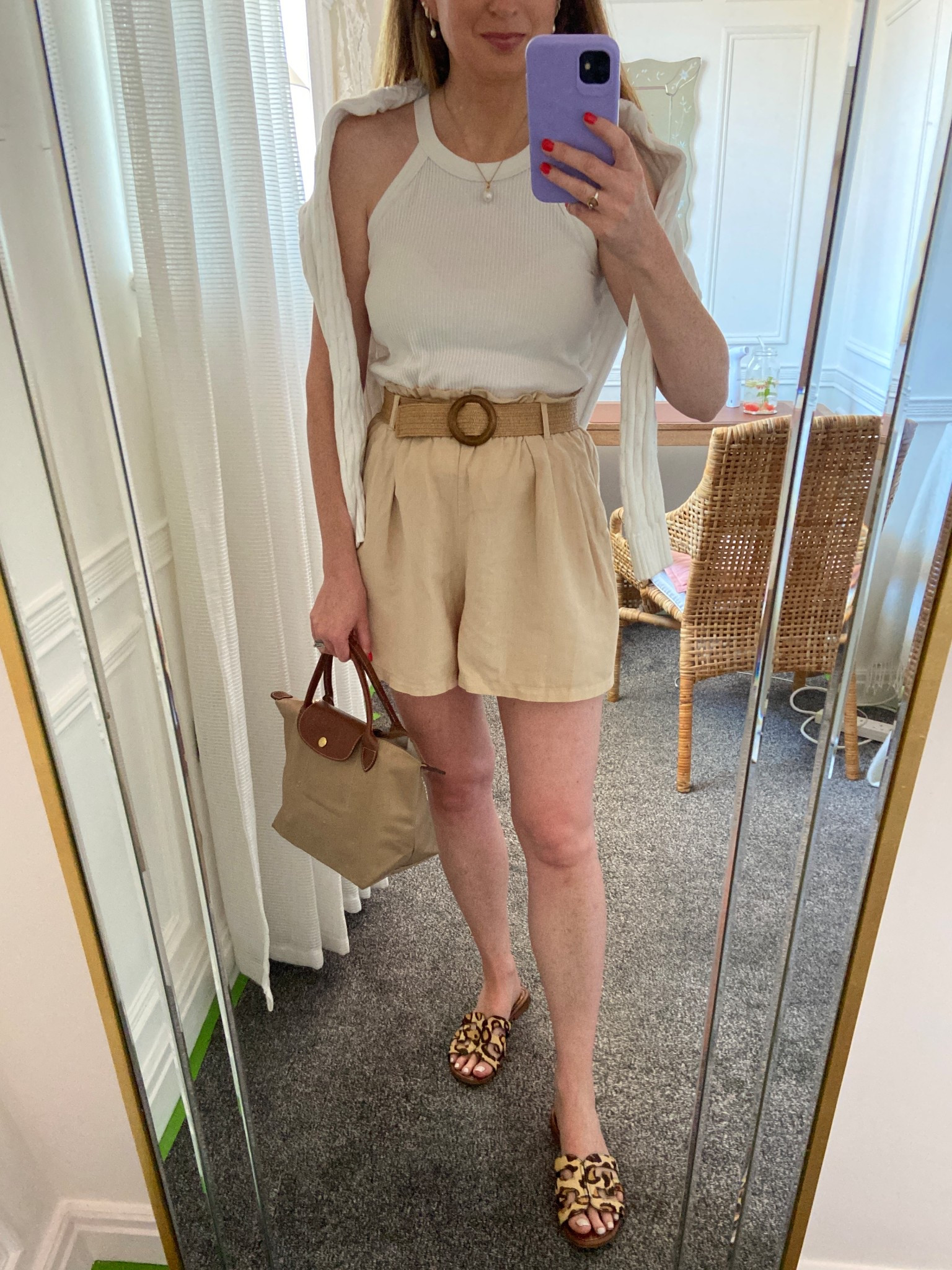 I love these Uniqlo halter bra tops — I have them in so many colors because they’re just so easy to throw on and go with everything! Paired them with my favorite high-waisted paperbag shorts and added a lightweight Ralph Lauren ribbed jumper around my shoulders for an effortless layered look. Finished it off with a classic tote and leopard slides for a fun pop. This is my go-to neutral summer outfit for casual days, travel, or just running errands in style. #summerstyle #uniqlofinds #ralphlauren #neutraloutfit #casualchic #effortlessstyle 

#LTKSeasonal #LTKStyleTip #LTKOver40