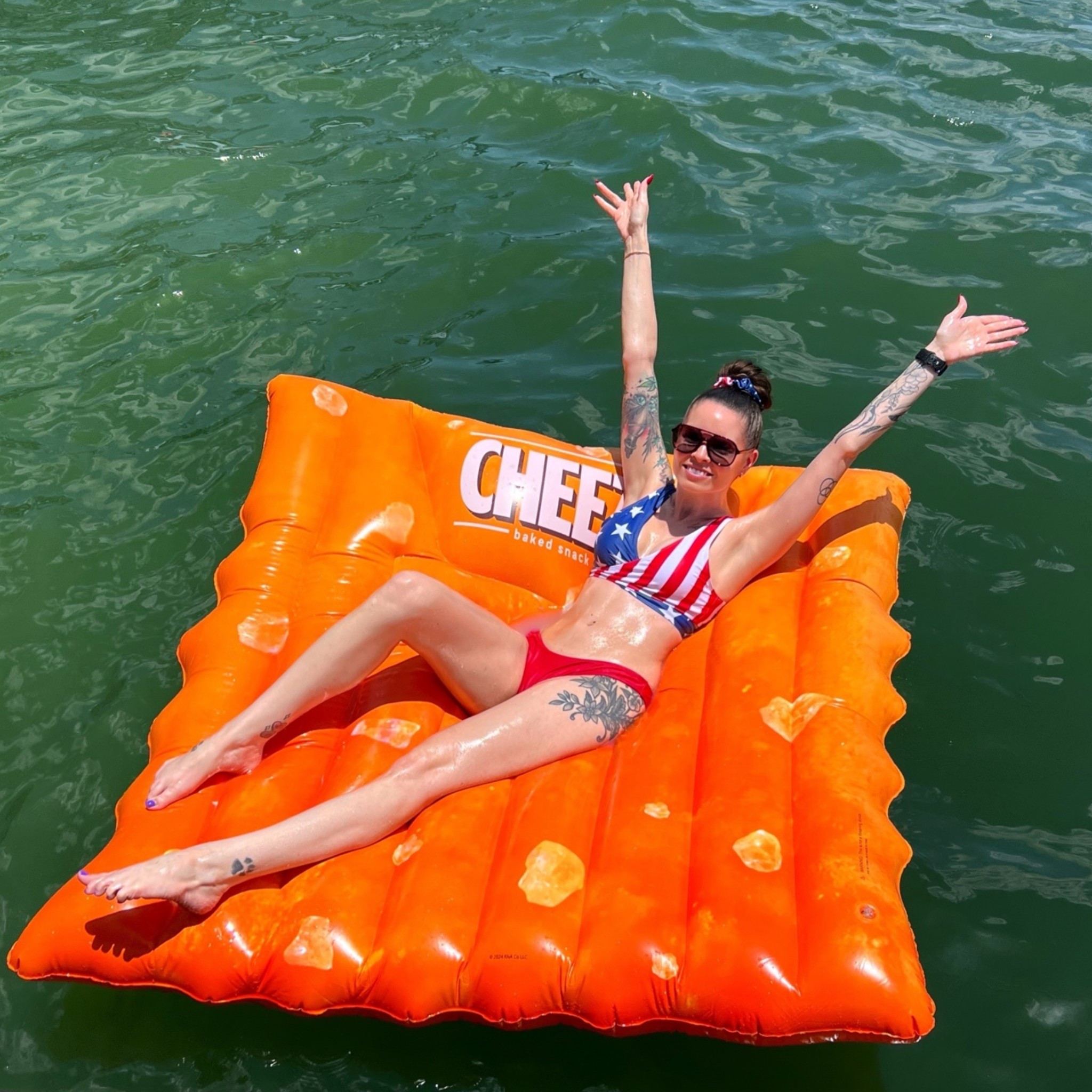 Yes, a cheeze it pool float exists and it’s hilarious