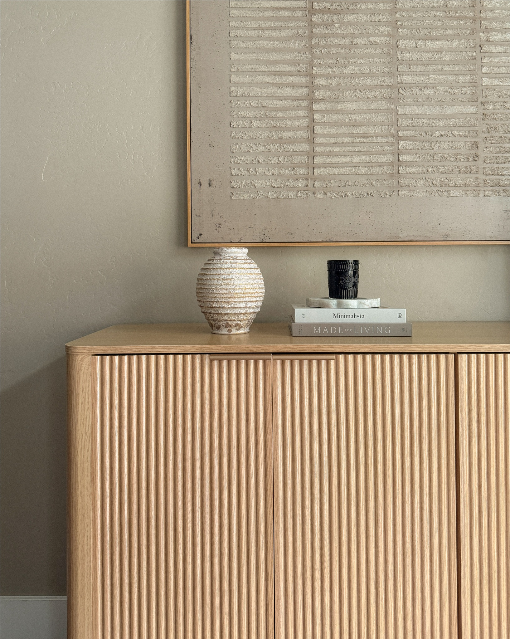 This natural fluted sideboard cabinet is one of my favorite pieces right now. The warm wood tone and fluted texture add so much character while keeping the space feeling light and modern.
It also has ample storage, which makes it perfect for hiding away dishes, linens, office supplies, or everyday clutter while still looking beautiful in the room.

#neutralhome #sideboardcabinet #cabinetstylung 

#LTKSaleAlert #LTKSpringSale #LTKHome
