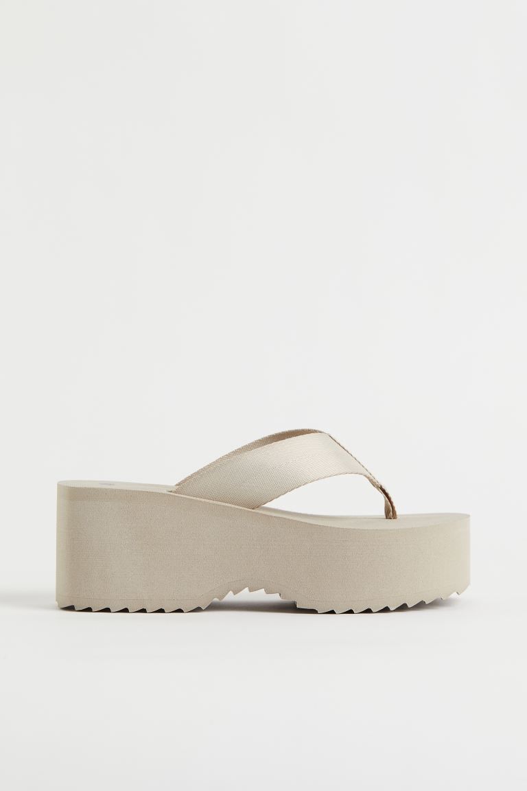 Platform flip-flops in woven fabric with narrow toe post, wide straps, and fluted soles. Front pl... | H&M (US + CA)