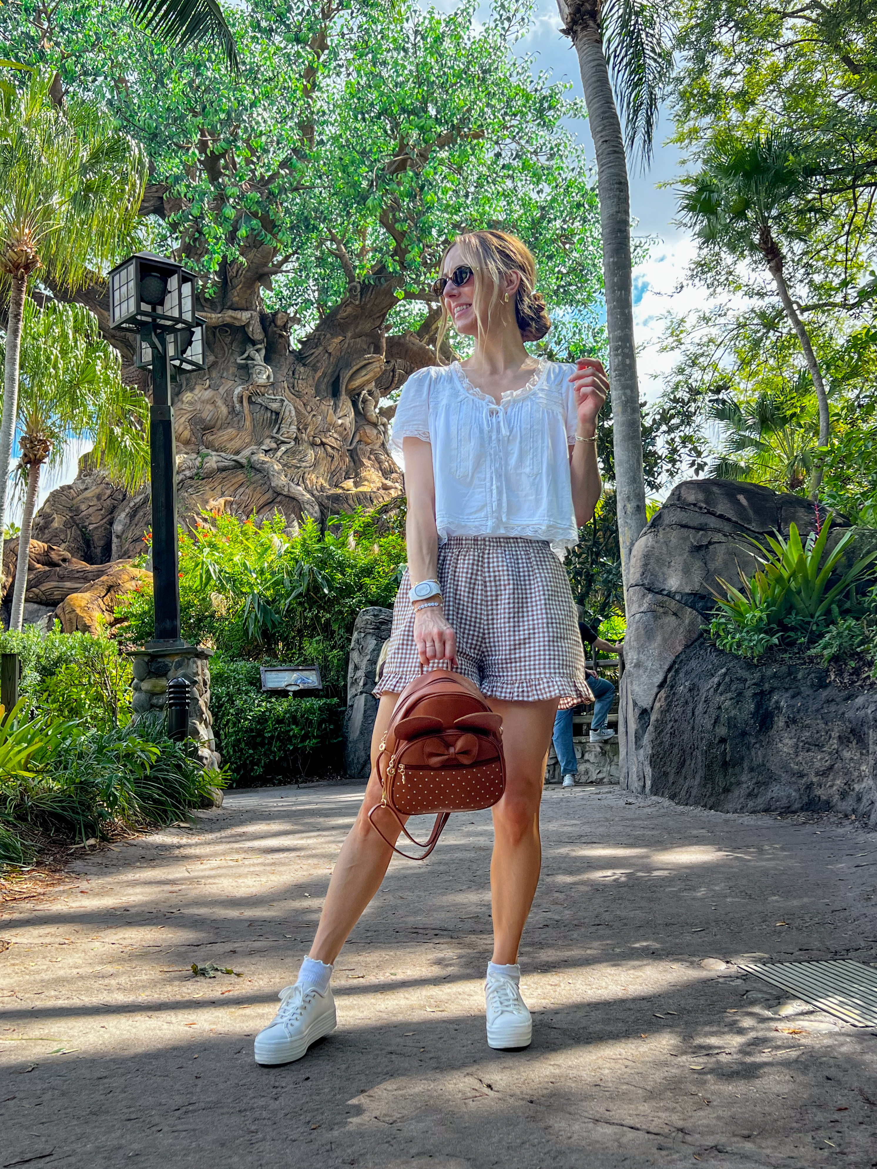 Day at the park! I love this Boho blouse paired with gingham flowy shorts and a Minnie backpack. The backpack is the perfect size and style for a day out. Comfortable and stylish! I'm in a medium for the blouse and shorts. Keds sneakers fit TTS.
 

 #LTKootd #LTKSeasonal #LTKOver40