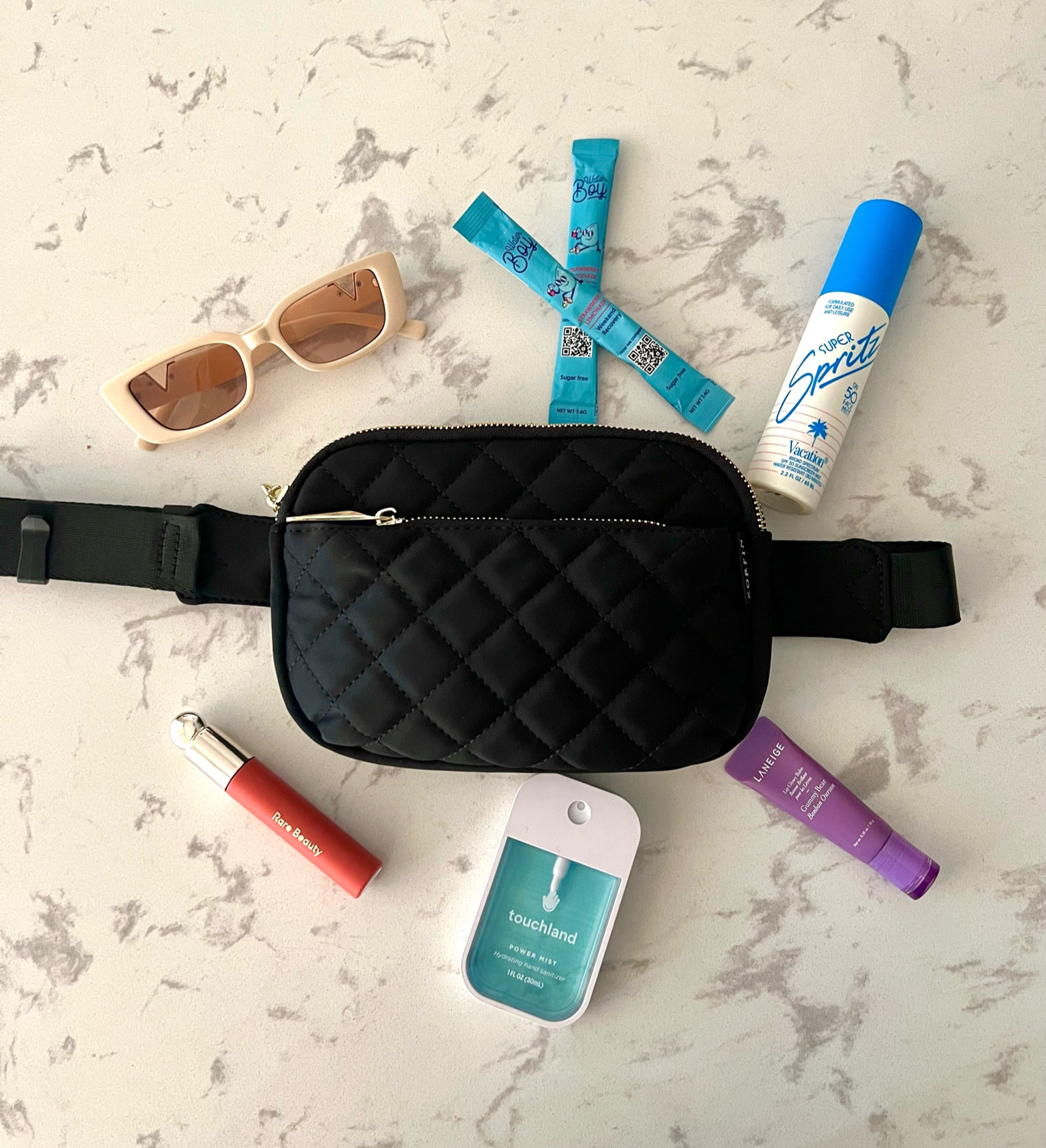 What’s in my bag summer edition! My daily must haves, I love these.

Amazon sunglasses - classic shape, great quality, and came in a pack of 2 (black and white)

Touchland hand sanitizer - smells great and the flat shape is ideas for purses or pockets

Vacation inc. Super Sprits - an SPF face mist that allows you to touch up your face sun screen all day even with make up on

Water Boy packets - fantastic hydration and way better than others I’ve had because of how low sugar is in it. Great flavor 

Rare Beauty Soft Pinch Tinted Lip Oil - the stain this leaves is amazing and the product consistency is a favorite of mine. Joy is the perfect summer color

Laneige Lip Glowy Balm - super moisturizing and the gummy bear flavor is fantastic 

Black Body Bag - affordable, great quality, and so much space 

#summer
#summeressentials 

#LTKbeauty #LTKtravel #LTKFind
