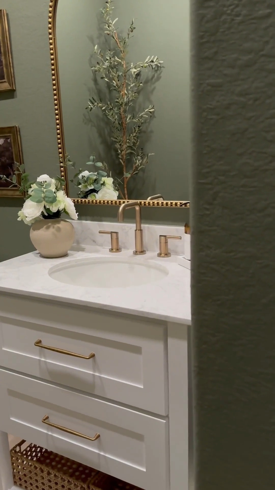If you’re considering color drenching a room green, I’m telling you, THIS might be the perfect color for you … go for it! 🤍

Walls & Ceiling - flat finish
Baseboards - satin finish

I was apprehensive but I decided to paint the ceiling 😬 …. Surprisingly it made the room feel larger! 

I chose brass finishes to create a vintage feel…, modern vintage perhaps …??? 😆.. 

The mirror is 30x40 inches… 

I added a new light fixture and it now faces upward … which makes that wall feel taller!

I wasn’t in love with this builder grade vanity tbh😆, matter-fact, I wanted to change it… it wasn’t functional …but now i wanna keep it lol 😂… I added brass hardware, cute baskets, led light strips on the bottom and now it’s a whole new unit….. you can even add battery powered/rechargeable/plug in led light strips .. whatever fits your lifestyle 

Ok let’s talk about this stunning planter!!! …. We all love an olive tree don’t we? 😆 … and I wanted something tall and slim… this planter was… perfect plus it added to the moody feeling of the room 🥰

#bathroommakeover #powderroom #powderroomdesign #homedecorideas #beforeafter

#LTKSaleAlert #LTKStyleTip #LTKHome