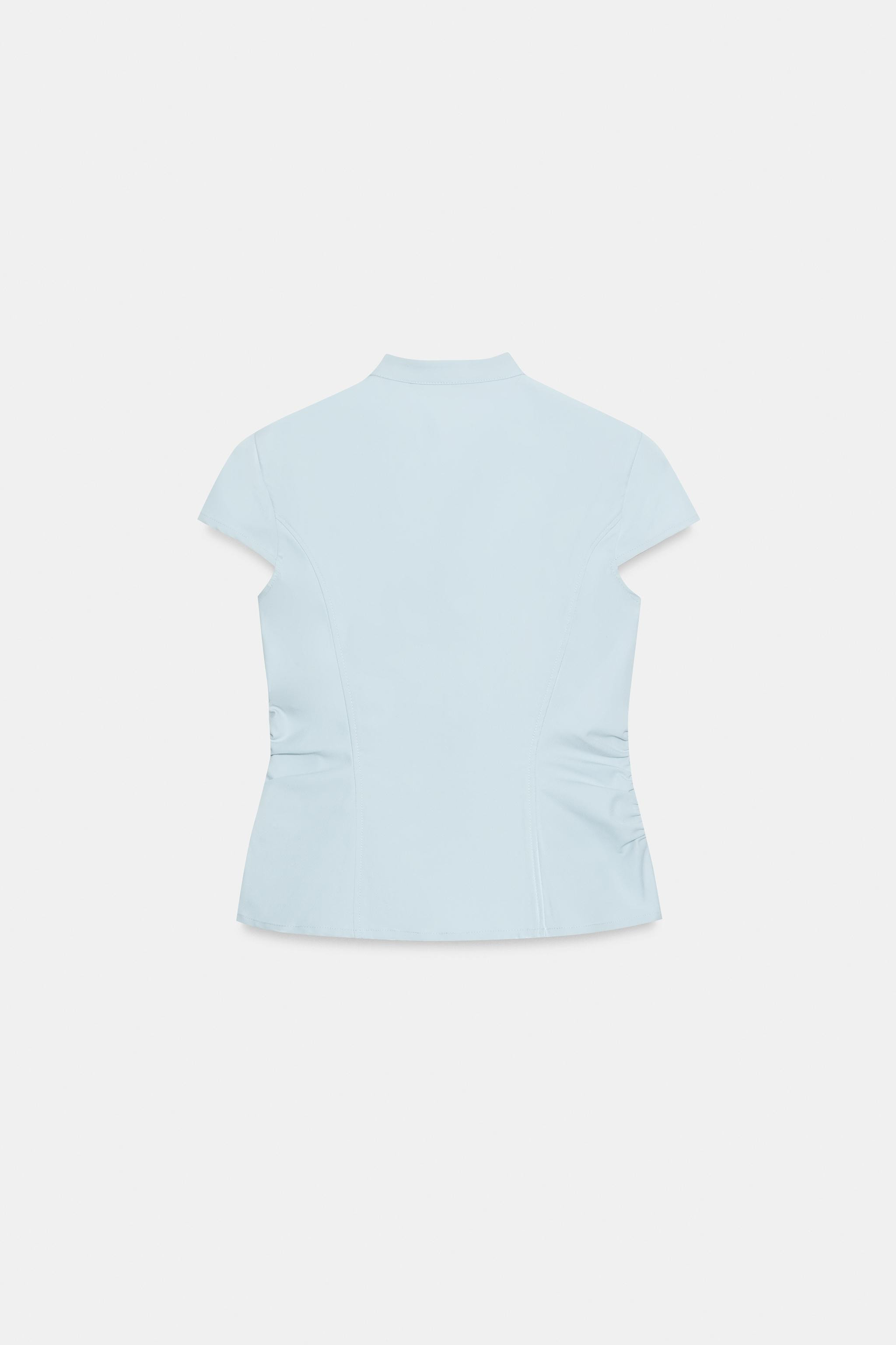 High-neck top with short sleeves, side gathering details and front zip fastening. | Zara UK