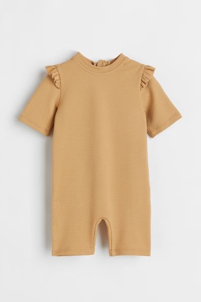 Swim jumpsuit in UV-protective material with a printed pattern. Low stand-up collar, ruffle trim ... | H&M (US + CA)