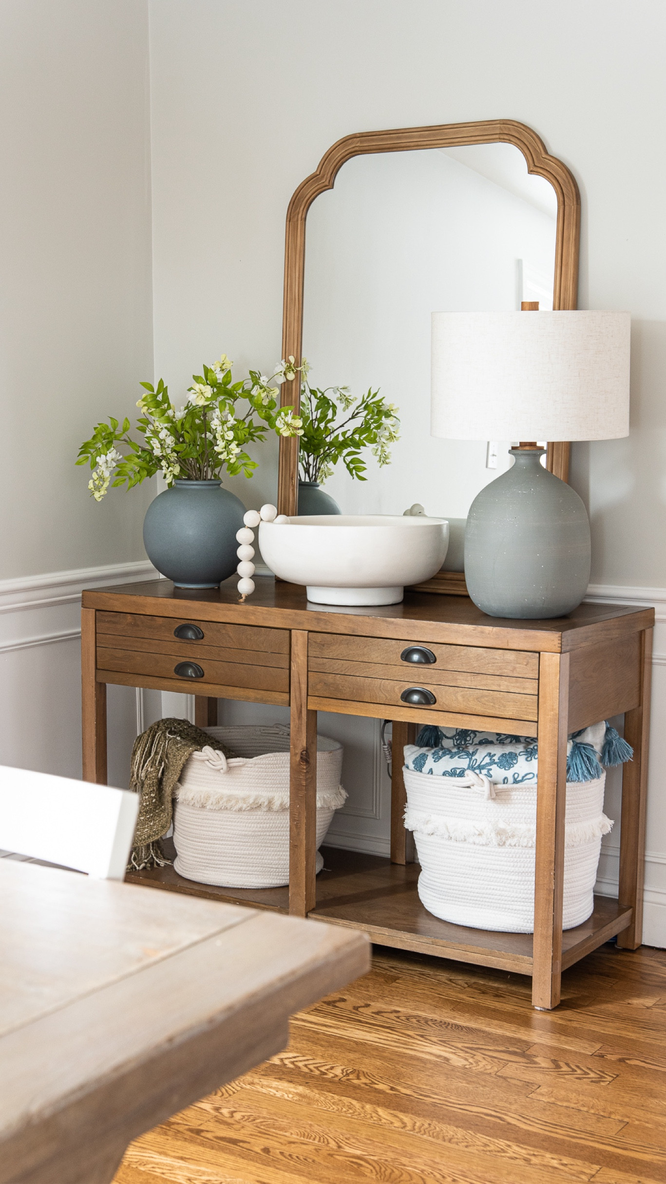 Coastal style console table with storage baskets, oversize mirror, decorative bowl, and beads, and more home accessories

#LTKHome #LTKFamily