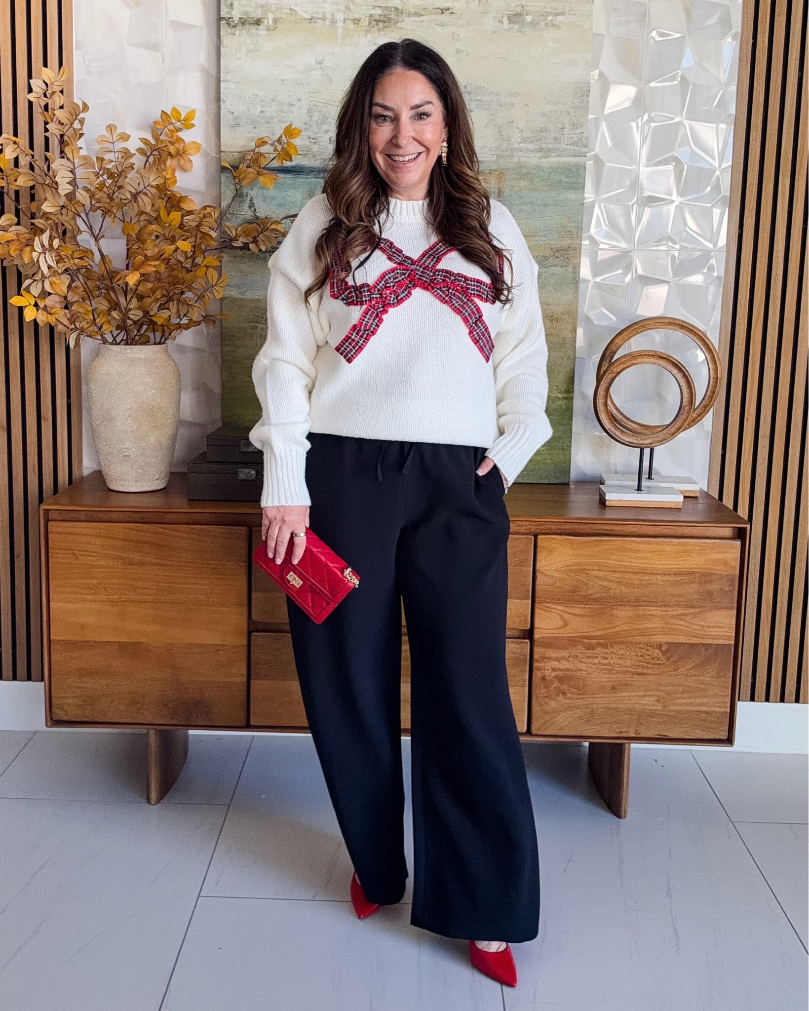 Tartan bow sweater + black wide-leg pants 🎀 Festive but so comfy for holiday gatherings! A red clutch and red pumps add the perfect pop of color ❤️ Sizing: Sweater, L | Pants, L