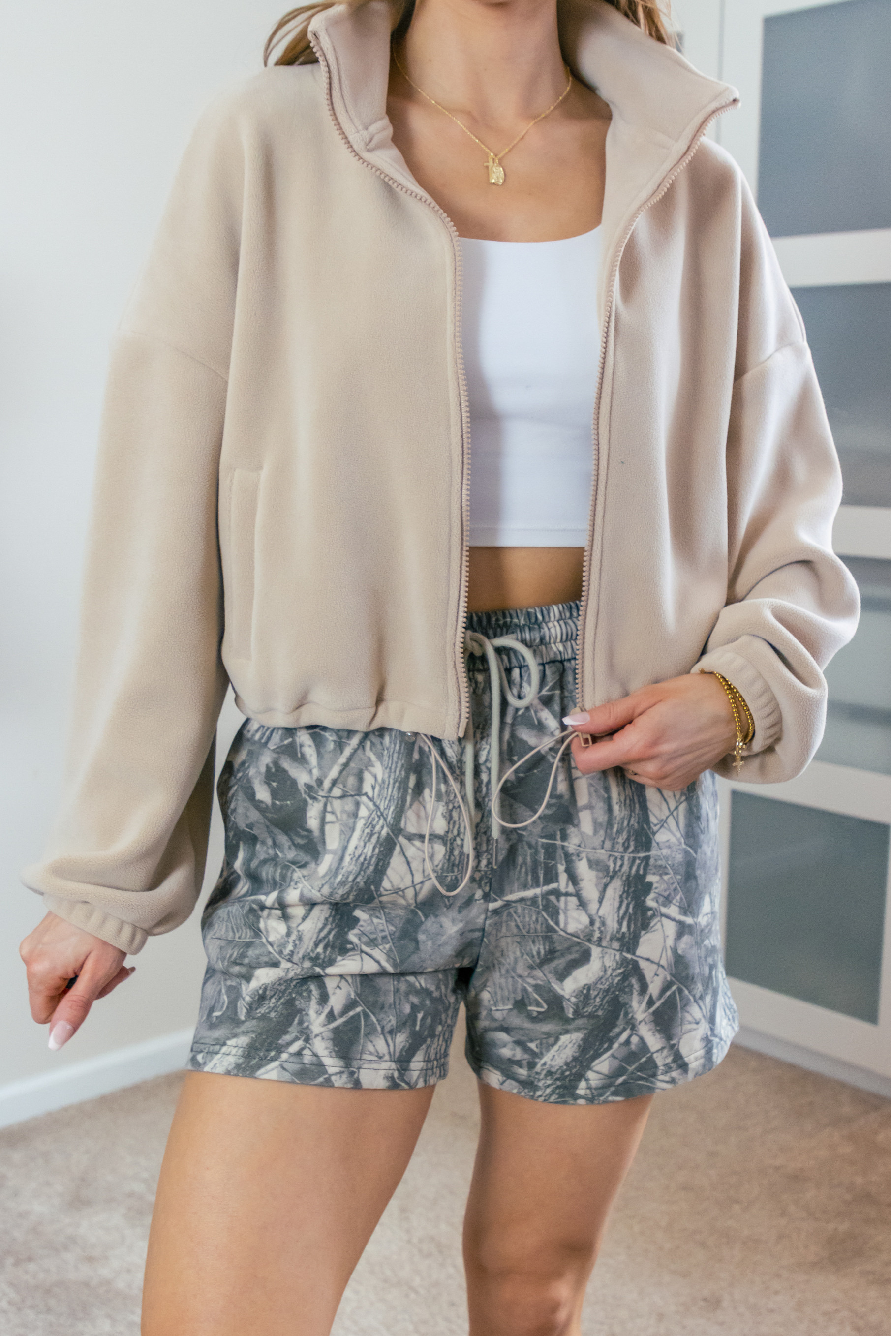 I'm loving this cozy fall outfit! These camo shorts are perfect for lounging around the house. Paired with a zip-up sweatshirt and some comfy socks, it's the ultimate comfy shorts outfit. 
>>>I'm in a size medium in the shorts and a size small in the crop jacket.

Check out my storefront for more outfit inspiration!
 

 #LTKootd #LTKSeasonal #LTKOver40