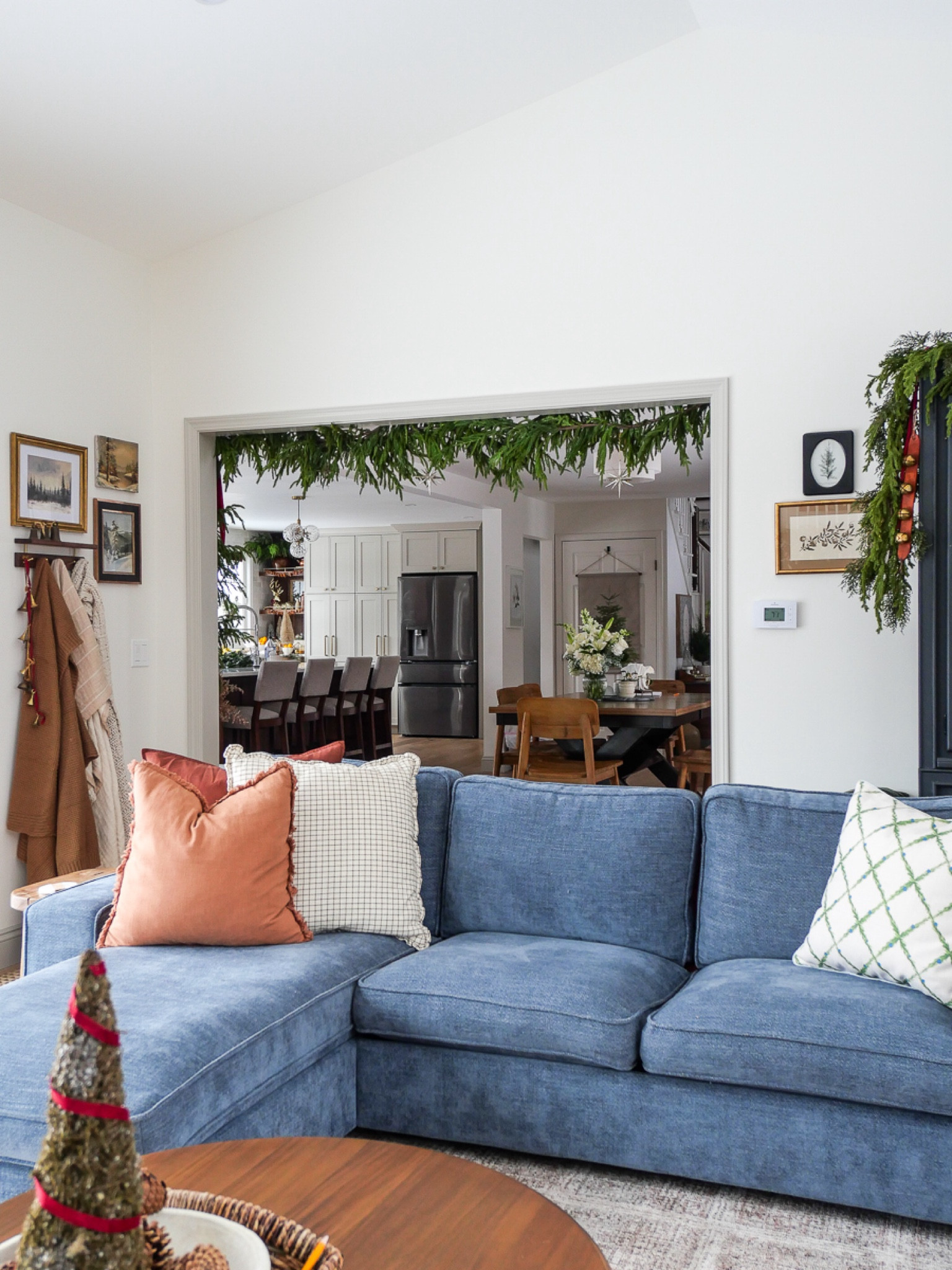 Living room furniture is easy to dress up with Christmas decor by adding a festive pillow and beautiful garland. Use wall space for blanket storage as well! 

#LTKCyberWeek #LTKHome #LTKHoliday