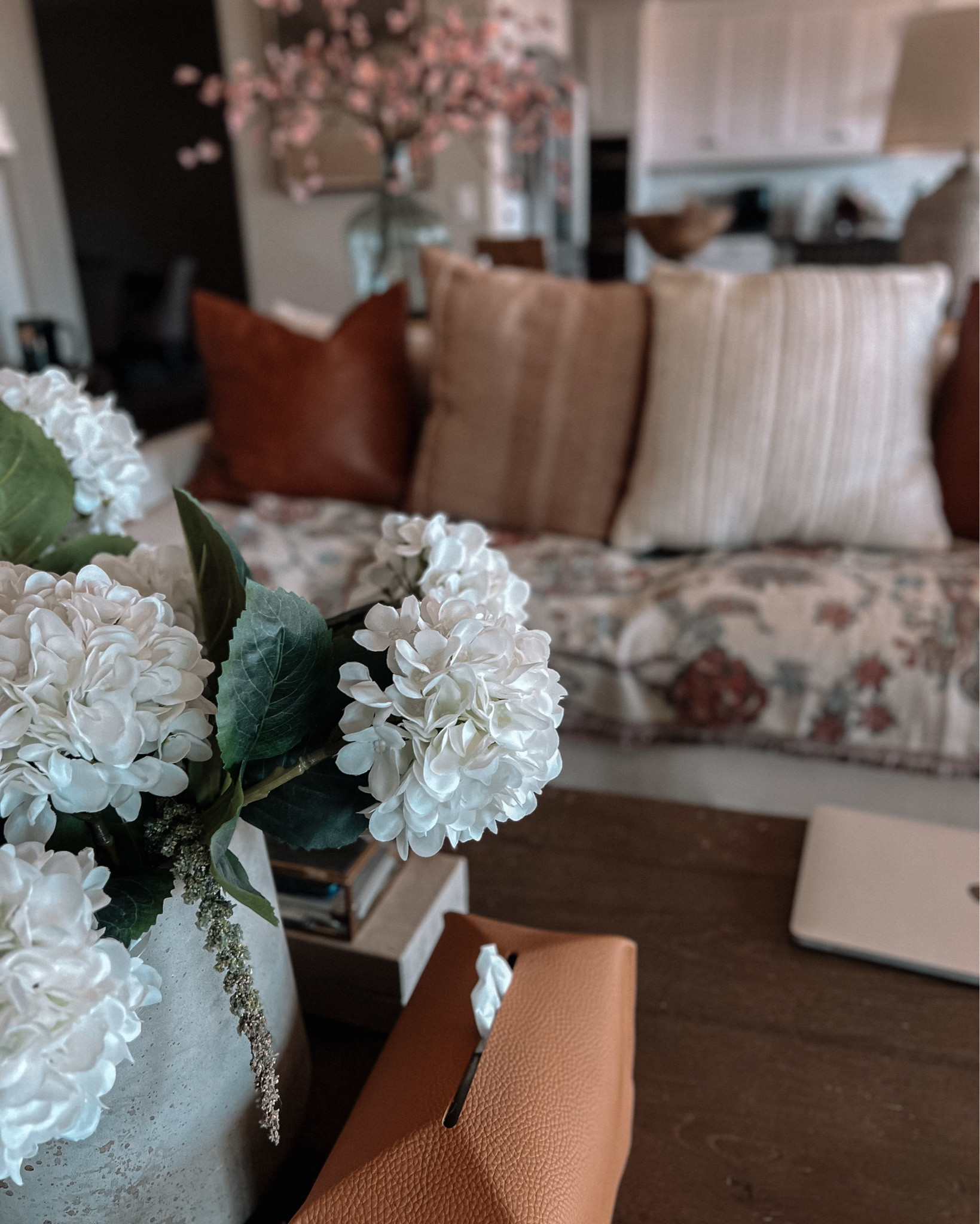 Spring is slowly making its way in over here, and I’m not mad about it. A floral throw, some textured pillows, and a fresh (faux) hydrangea moment—simple swaps that make the whole space feel lighter and more inviting. Also, can we take a second to appreciate this leather tissue box cover? Because if my allergies are going to act up, at least my tissues can look good while I battle them.

If you’re craving a little seasonal refresh without the effort of a full makeover.

#SpringTouches #CozyMeetsFresh #LTKhome