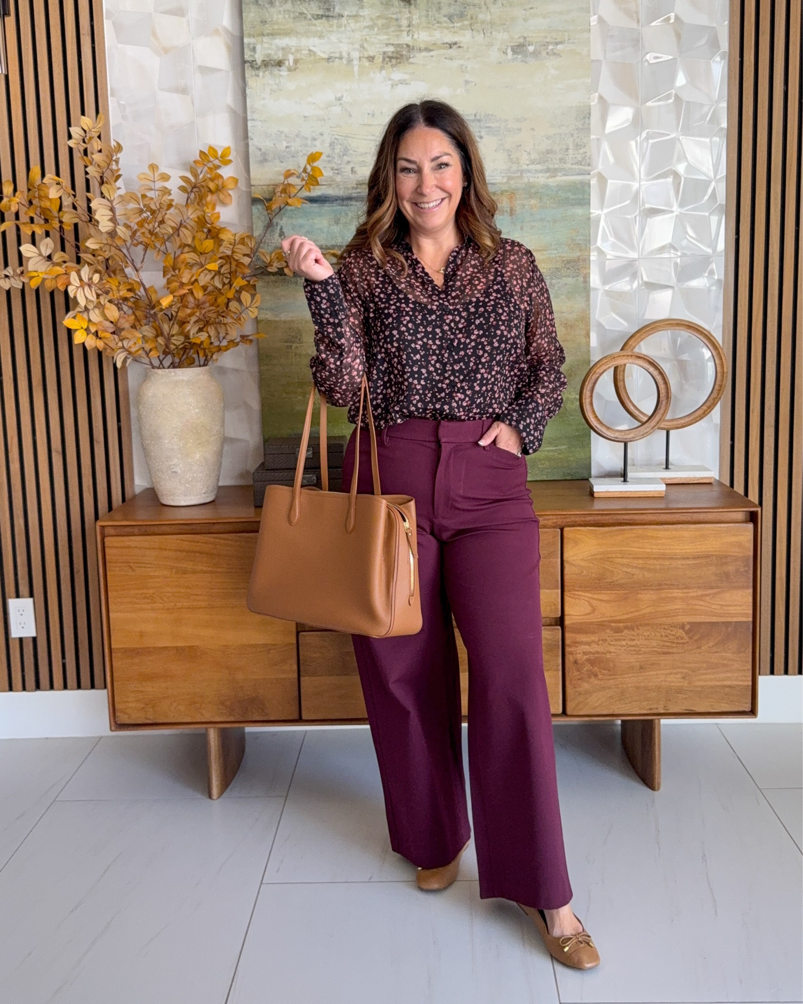 Fall workwear outfit idea 🍷 @oldnavy Black and pink floral sheer blouse tucked into burgundy wide-leg trousers, styled with a cognac tote and brown ballet flats. A pretty print-meets-wine teacher outfit and business casual look.

Sizing: Pants run small wearing 12, need 14 | top tts, L

#LTKOver40 #LTKMidsize #LTKWorkwear
