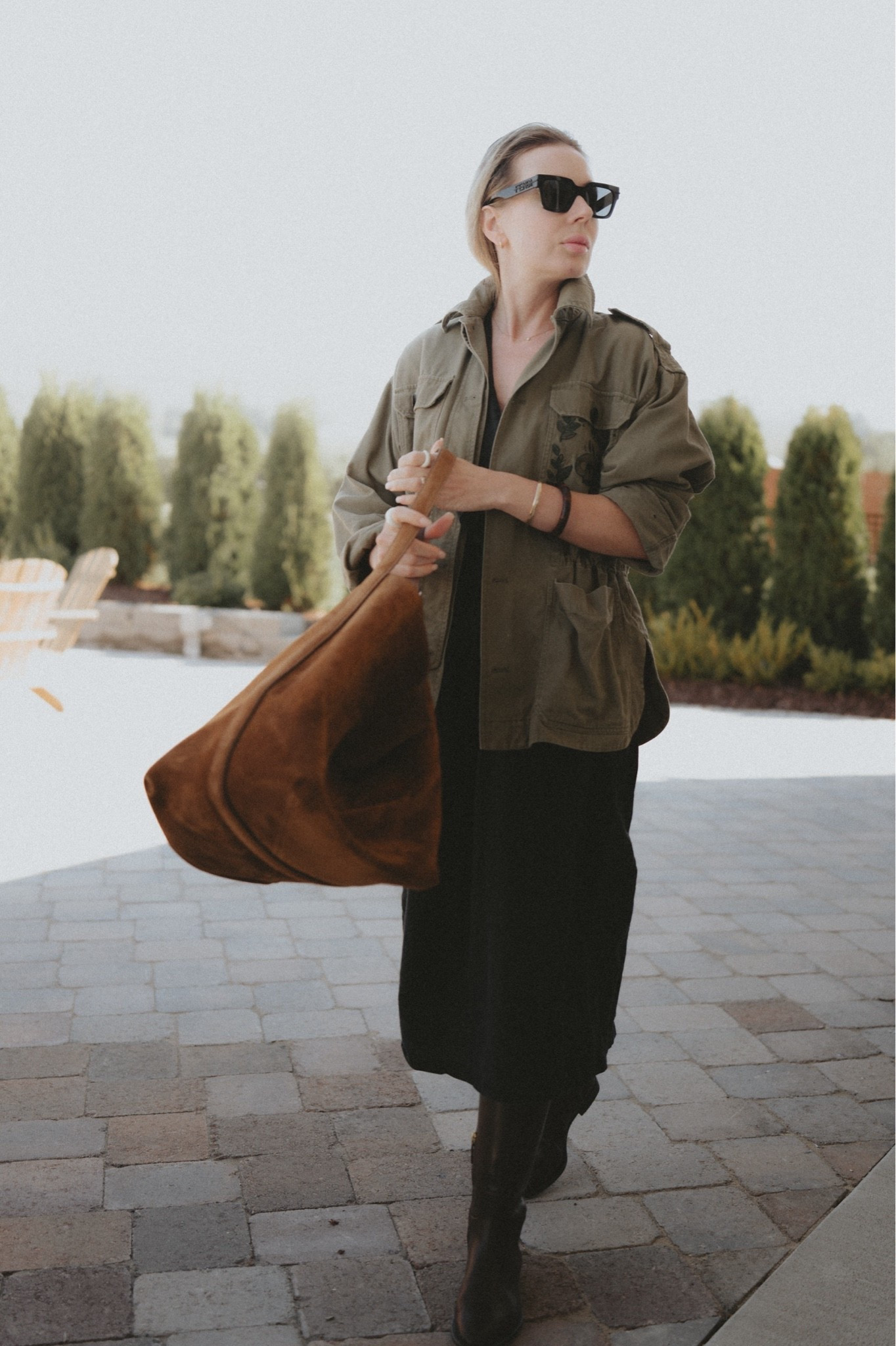 Khaki utility jacket + black midi dress + knee high brown riding boots + oversized hobo bag in caramel suede. 
Army style jacket: @Zadig And Voltaire utility jacket 
A-line dress: Mango black linen dress (older, similsimilar a linked) 
Riding boots: Ralph Lauren collection 
Bag: Toteme belted tote.