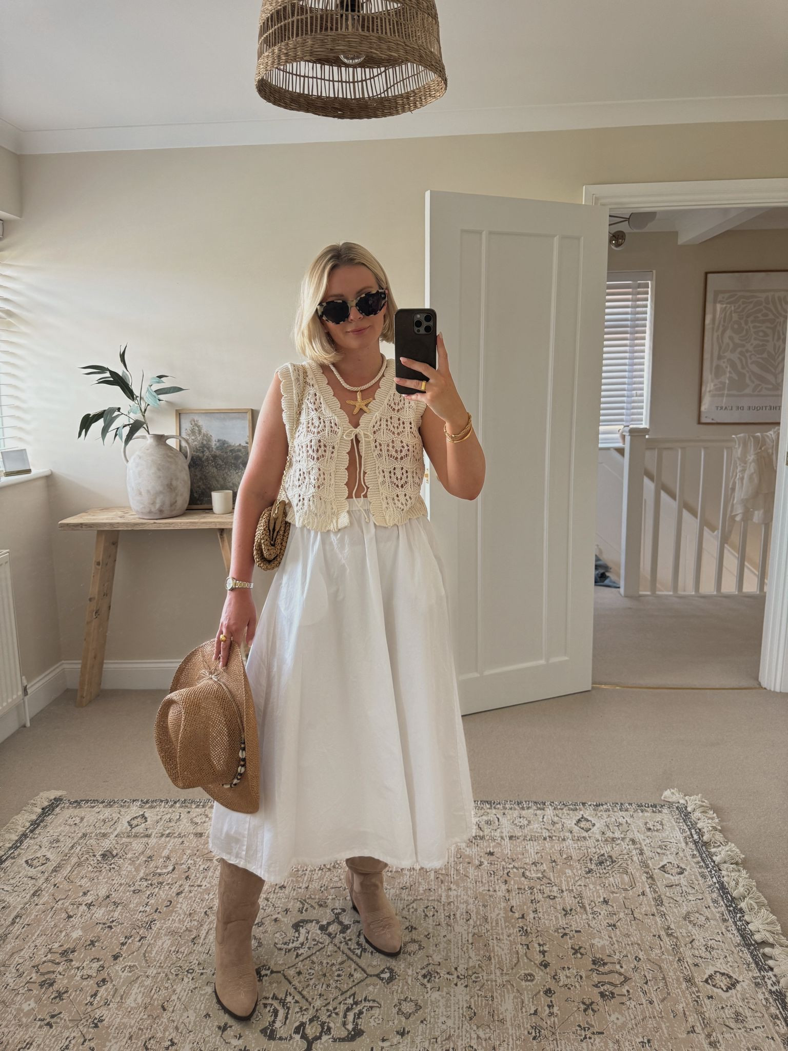 Chic summer festival & Ibiza outfit ideas - asos crochet cream waistcoat, M&S white cotton a line midi skirt, raffia cowboy hat, starfish necklace, & other stories tortoiseshell cat eye sunglasses, mango raffia clutch bag, beige suede cowboy boots 

#LTKsummer #LTKstyletip #LTKuk